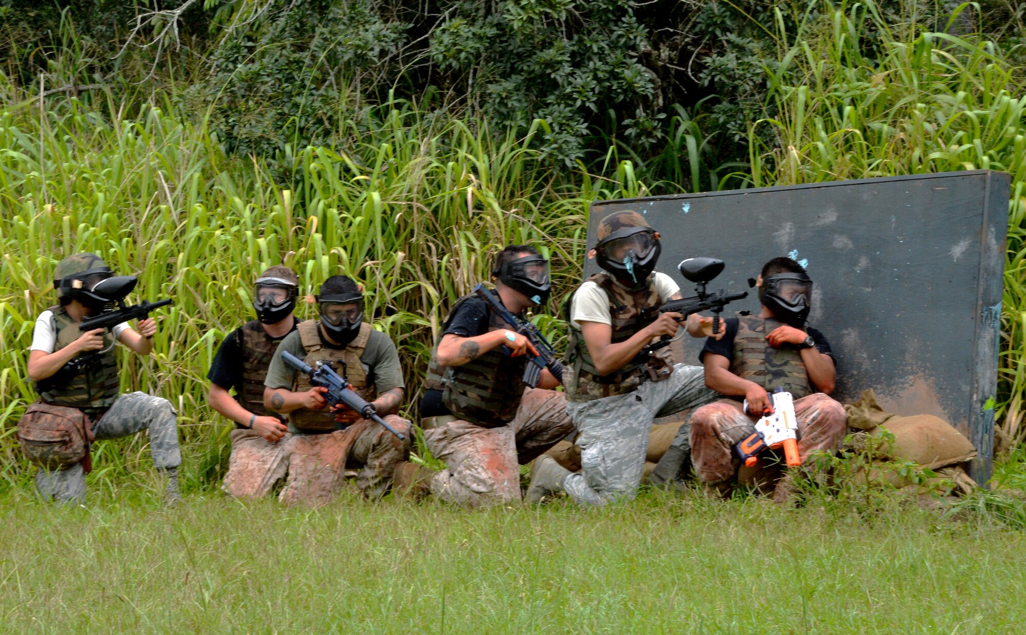 Air Force students and Navy Tactical Combat Casualty Care course instructors prepare to navigate through a simulated combat zone in order to evacuate injured casualties during a TCCC course at Schofield Barracks, Hawaii, May 2, 2014. During the 3-day course, Navy and Air Force medics were instructed on how to provide casualty care in a combat environment. (U.S. Air Force photo/Staff Sgt. Alexander Martinez)