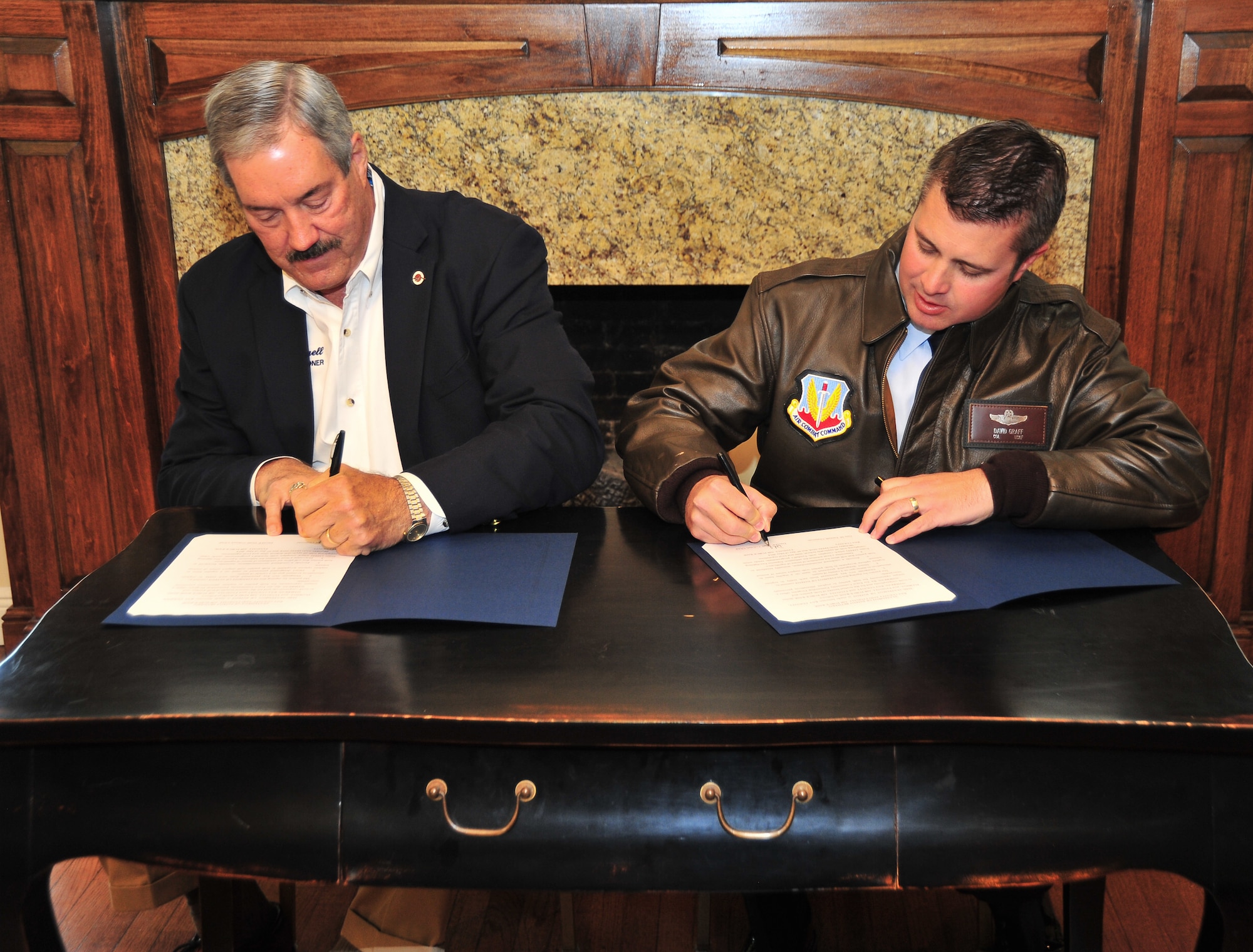 From left to right: Guy M. Tunnell, Bay County’s District 4 commissioner, and Col. David E. Graff, 325th Fighter Wing commander, sign a letter of intent May 2 as part of the P4 initiative, or Public-Public; Public-Private Partnerships. The P4 program is a way for Air Force bases and their local communities to save money by using each other's assets creatively to solve problems. (U.S. Air Force photo by Airman 1st Class Sergio A. Gamboa)