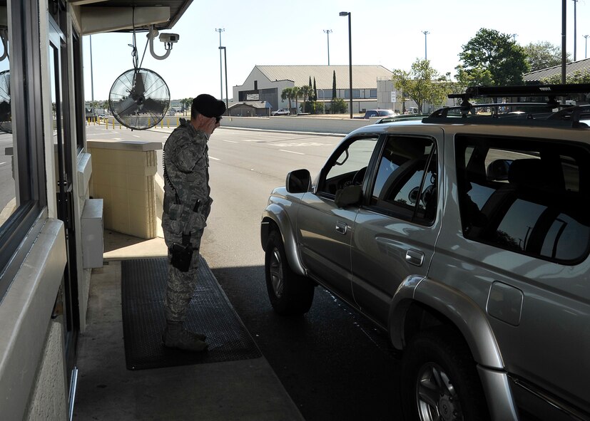 Airman 1st Class Jarred Uzeta, 325th Security Forces Squadron response force member, salutes an officer May 6 at Tyndall gate. Security Forces guard the installation entrances 24/7. (U.S. Air Force photo by Airman 1st Class Solomon Cook)