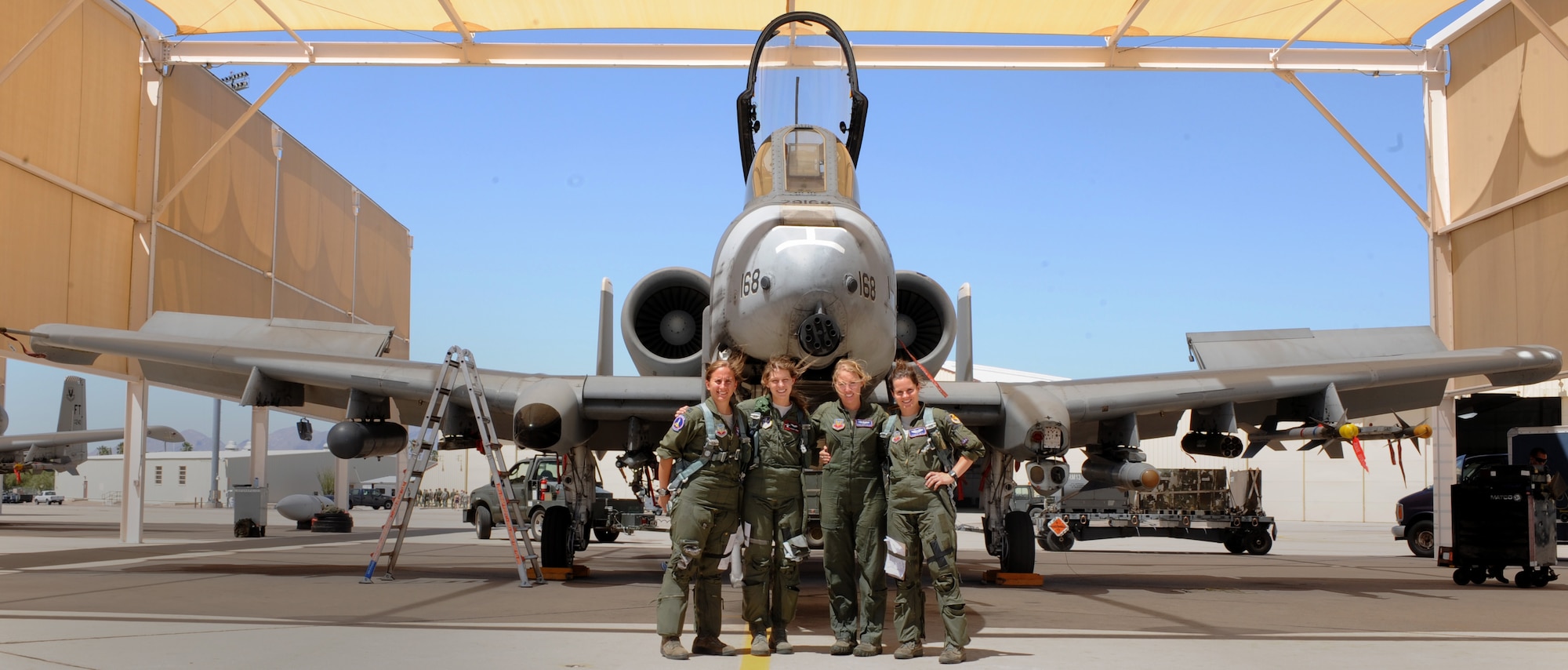 U.S. Air Force Capt. Rachel Winiecki, Capt. Kelly Nettleblad, and 1st Lt. Jessica Wyble, 354th Fighter Squadron A-10 pilots, and 1st Lt. Katherine Conrad, 107th FS Selfridge Air National Guard Base, Michigan, A-10 pilot, pose in front of an A-10 at Davis-Monthan Air Force Base, Ariz., May 5, 2014. This was Capt. Nettleblad’s final flight as part of the 354th. It was also an opportunity to make history by being the first four ship of all-female pilots.(U.S. Air Force photo be Airman 1st Class Cheyenne Morigeau/ Released)