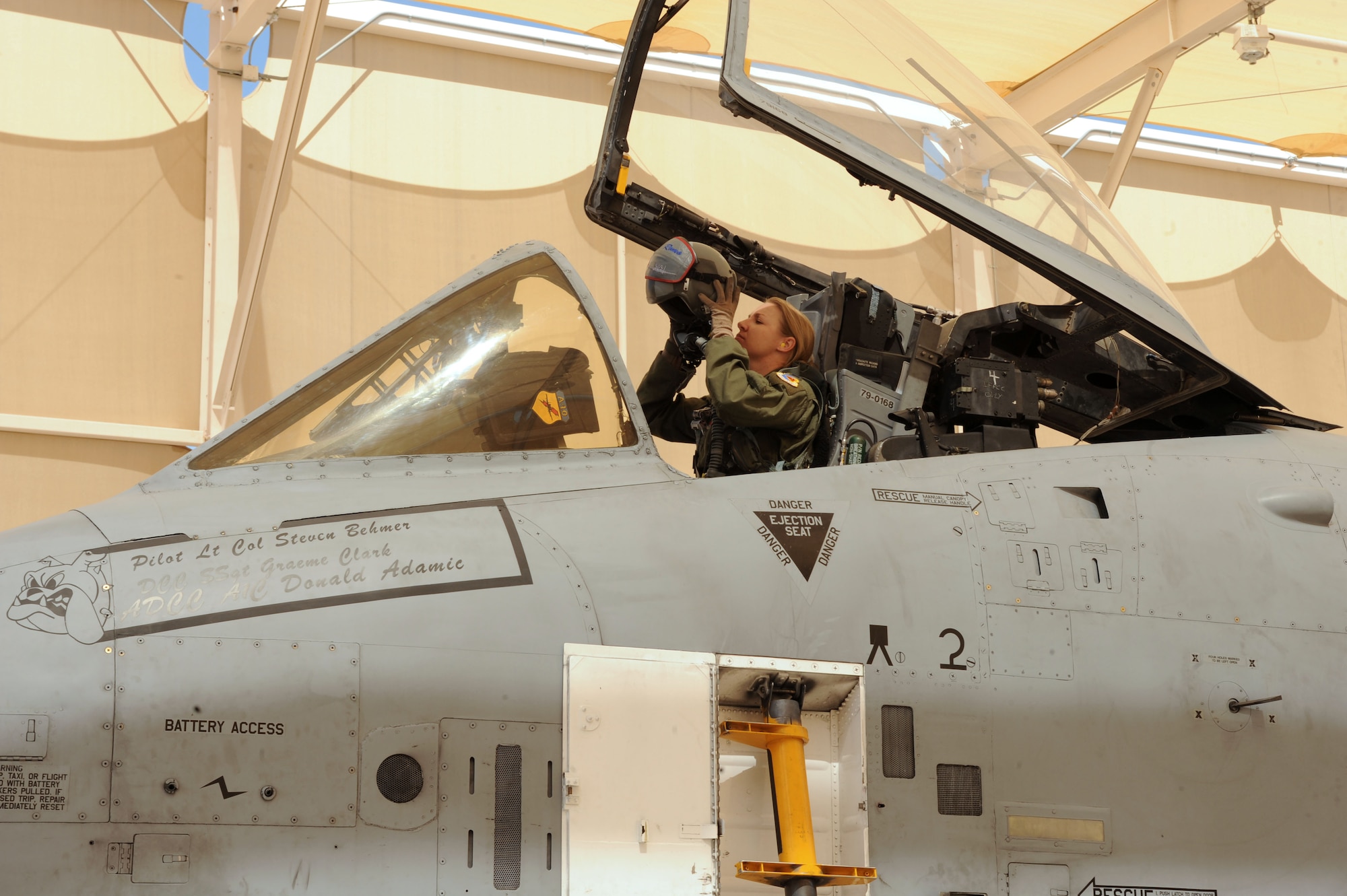 U.S. Air Force Capt. Kelly Nettleblad, 354th Fighter Squadron A-10 pilot, puts on her flight helmet in preparation for her final flight at Davis-Monthan Air Force Base, Ariz., May 5, 2014. For Nettleblad’s  fini flight, she departed D-M in an all-female four ship. (U.S. Air Force photo be Airman 1st Class Cheyenne Morigeau/Released)