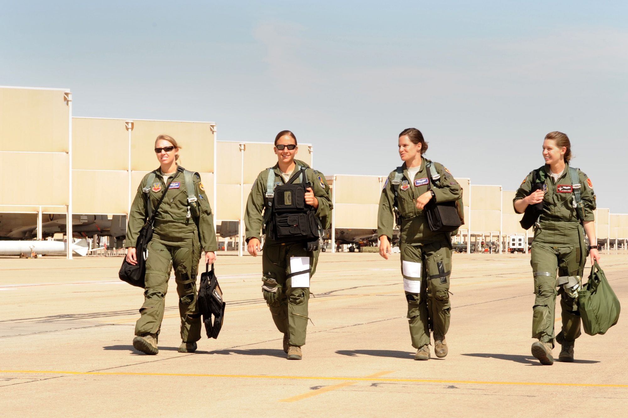 U.S. Air Force Capt. Kelly Nettleblad, Capt. Rachel Winiecki and 1st Lt. Jessica Wyble, 354th Fighter Squadron A-10 pilots and 1st Lt. Katherine Conrad 107th FS Selfridge Air National Guard Base, Michigan, A-10 pilot, walk across the flight line to their aircraft at Davis-Monthan Air Force Base, Ariz., May 5, 2014. They flew in a four ship together for Nettleblad’s final flight with the 354th Bulldogs. (U.S. Air Force photo be Airman 1st Class Cheyenne Morigeau/Released) 