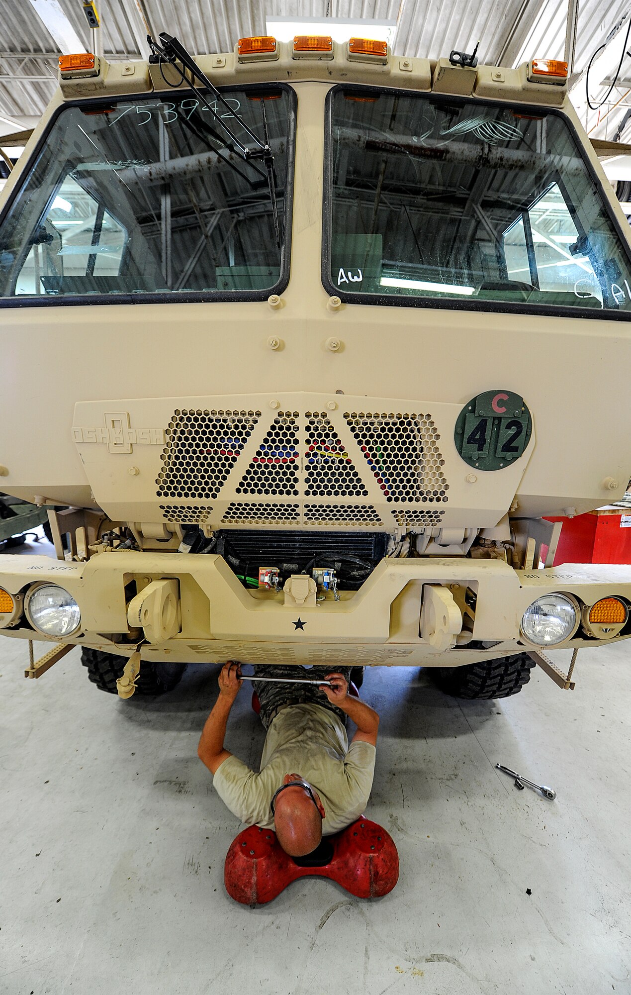 Staff Sgt. Matthew Di Terlizzi, 1st Special Operations Logistics Readiness Squadron vehicle maintenance specialist, unscrews a panel on a military truck at Hurlburt Field, Fla., April 28, 2014. The vehicle maintenance flight manages a fleet of approximately 600 base-wide vehicles and trains all vehicle control officers. (U.S. Air Force photo/Senior Airman Christopher Callaway)