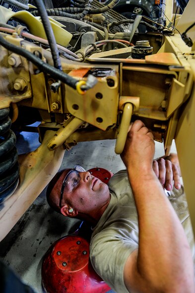 Staff Sgt. Matthew Di Terlizzi, 1st Special Operations Logistics Readiness Squadron vehicle maintenance specialist, tightens a bolt on a Humvee at Hurlburt Field, Fla., April 28, 2014. Vehicle maintenance is responsible for keeping 1st Special Operations Wing vehicles serviceable at all times. (U.S. Air Force photo/Senior Airman Christopher Callaway)  