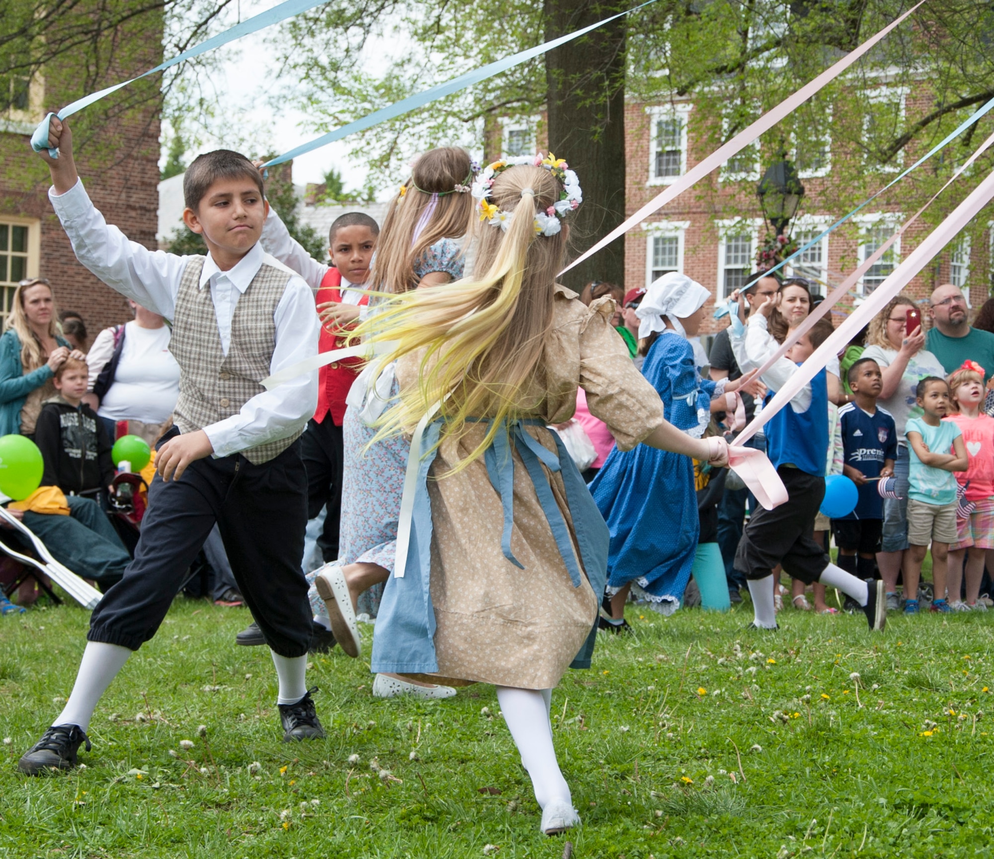 Children from Major George S. Welch Elementary School on Dover Air Force Base dance around the maypole during the Dover Days celebration May 3, 2014, in downtown Dover, Del. The children also walked in the parade demonstrating customs and courtesies, with the boys bowing and the girls curtseying. (U.S. Air Force photo/Senior Airman Jared Duhon) 