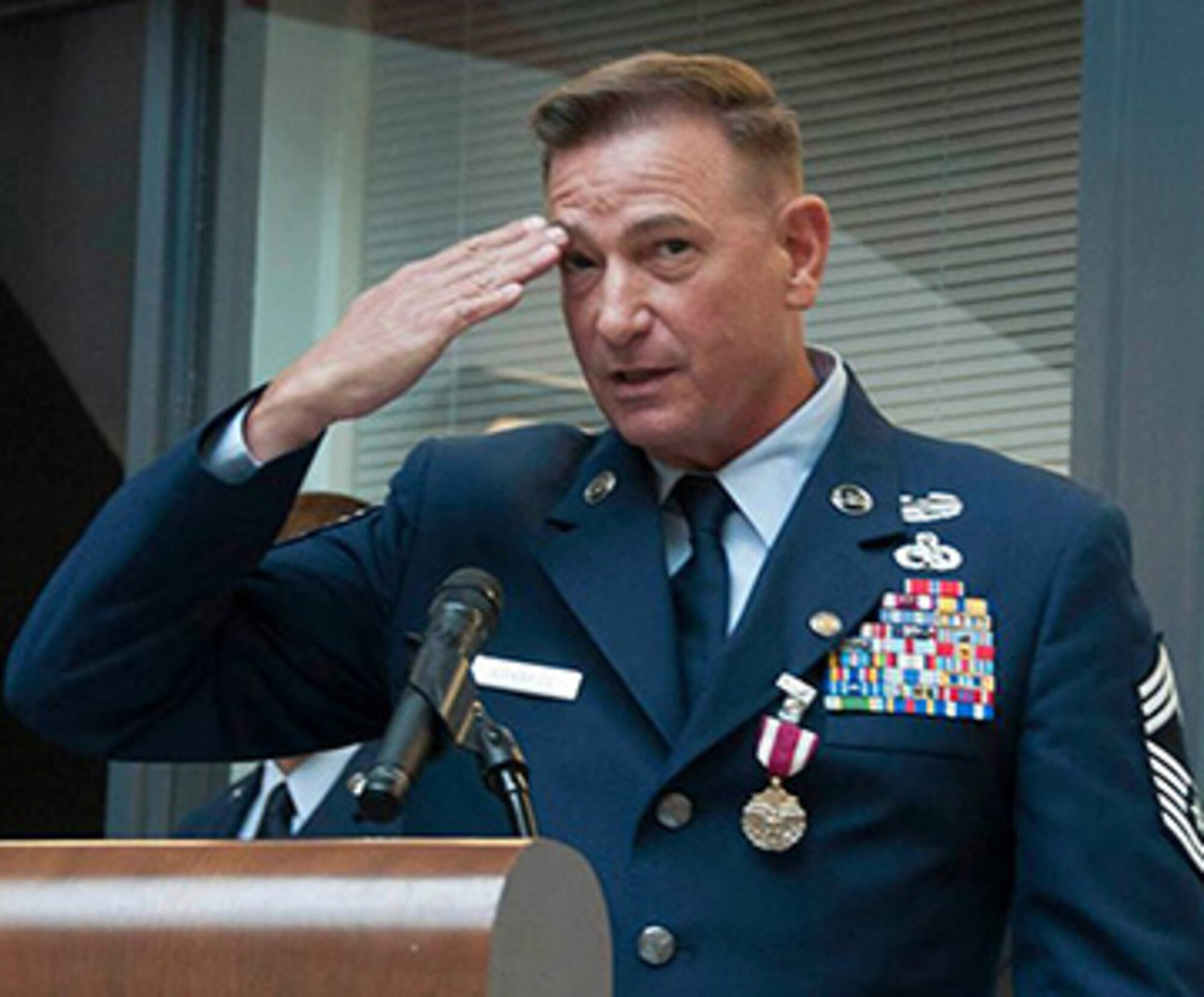 TRAVIS AIR FORCE BASE, Calif. -- Chief Master Sgt. Terry Kirkbride, 349th Maintenance Squadron superintendent, salutes the service members, past and present, in attendance at his retirement ceremony April 26, 2014, at Travis Air Force Base, Calif. Since joining the Air Force in 1978, Kirkbride has spent more than three decades in service, all at Travis Air Force Base. (U.S. Air Force photo/Master Sgt. Rachel Martinez)