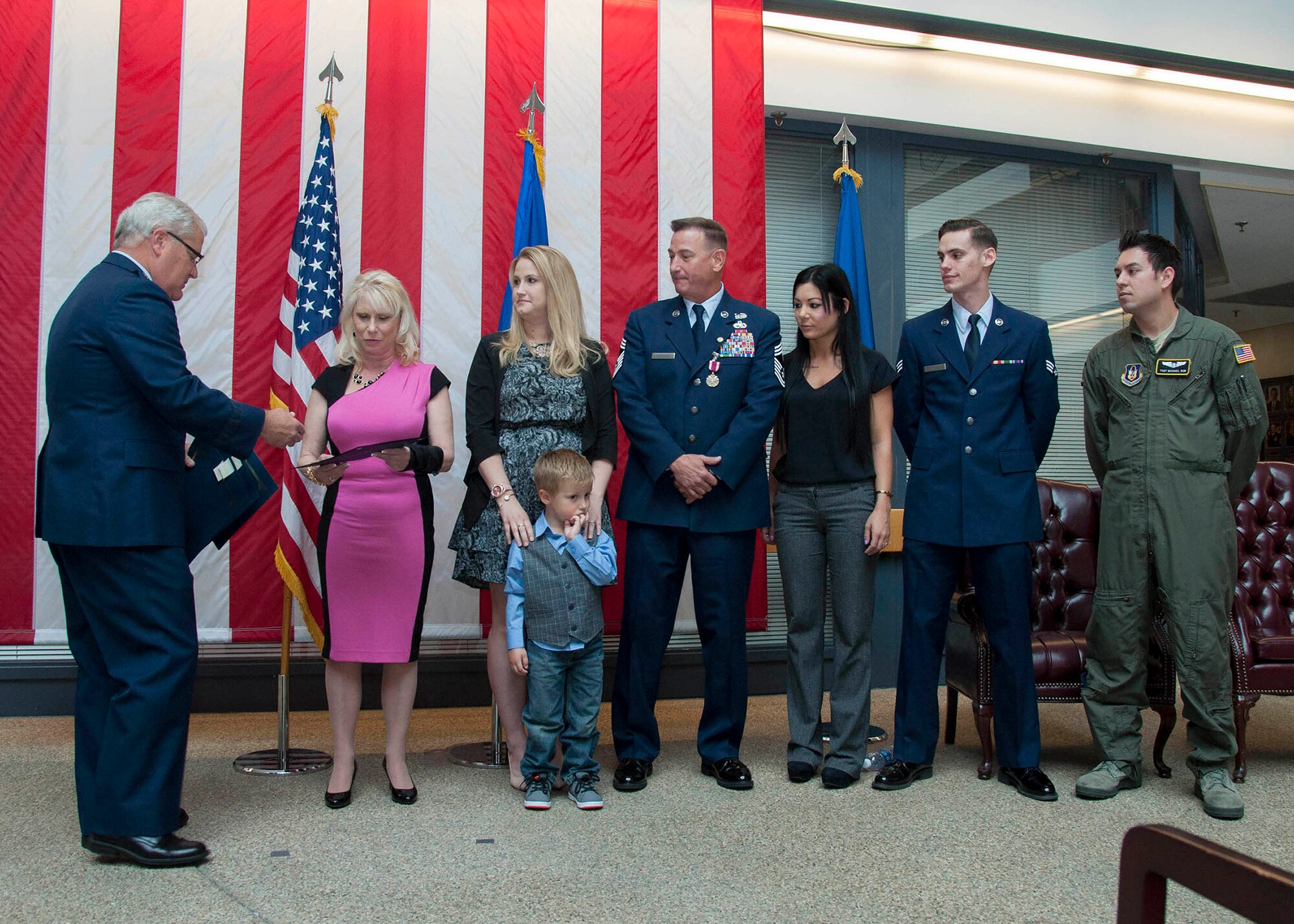 TRAVIS AIR FORCE BASE, Calif. -- Retired Brig. Gen. James Melin presents certificates of appreciation to Chief Master Sgt. Terry Kirkbride’s family members on the occasion of his retirement ceremony April 26, 2014, at Travis Air Force Base, Calif. Melin, who also happens to be Kirkbride’s brother-in-law, presided over the official ceremony. (U.S. Air Force photo/Master Sgt. Rachel Martinez) Digital