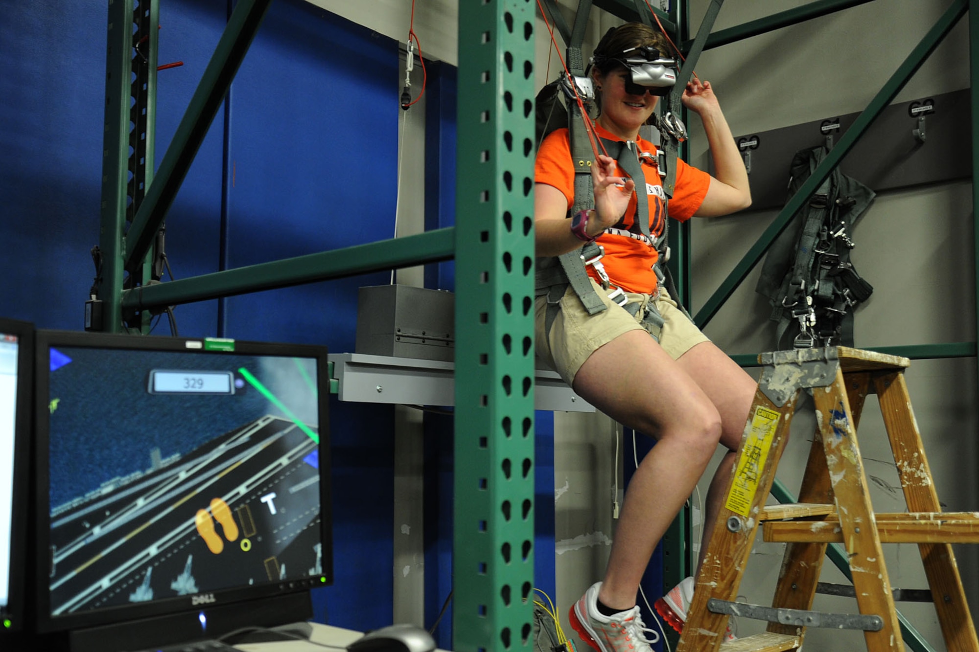 A Spokane Shock staff member works the parachute simulator during a base tour at Fairchild Air Force Base, Wash., May 2, 2014. Survival, Evasion, Resistance and Escape Airmen showed Spokane Shock arena football players and staff members the exhibits lab, parachute simulator and demonstrated combative maneuvers. (U.S. Air Force photo by Airman 1st Class Janelle Patiño/Released)