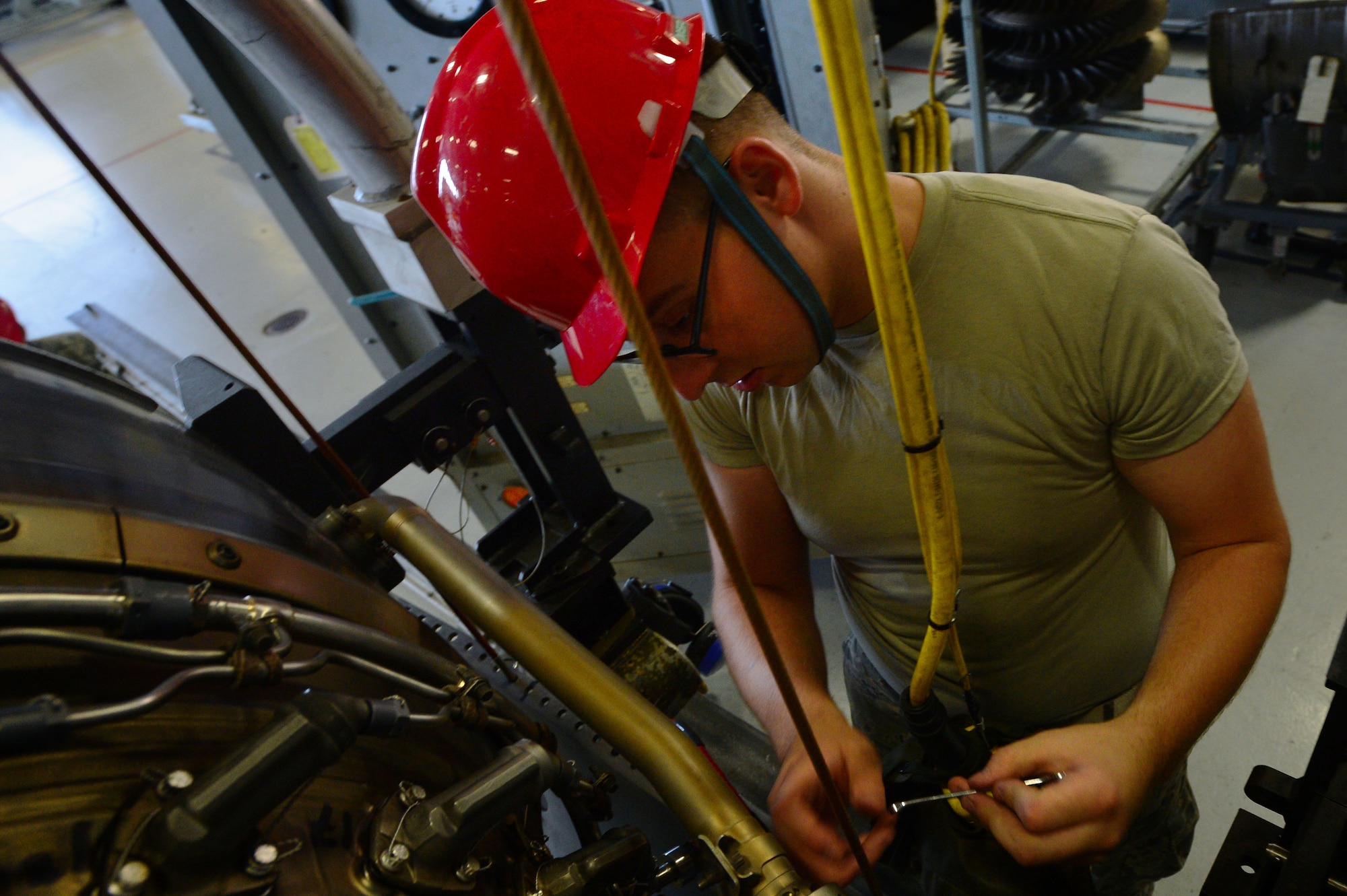 U.S. Air Force Airman Tyler Wright, 20th Component Maintenance Squadron aerospace propulsion technician, prepares the lower outer fan duct on an F110-General Electric-129 jet engine during Operational Readiness Exercise Weasel Victory 14-06 at Shaw Air Force Base, S.C., May 6, 2014. The fan duct protects the engines razor sharp fans which run at a maximum speed of 8,200 rotations per minute. (U.S. Air Force photo by Airman 1st Class Jensen Stidham/Released)