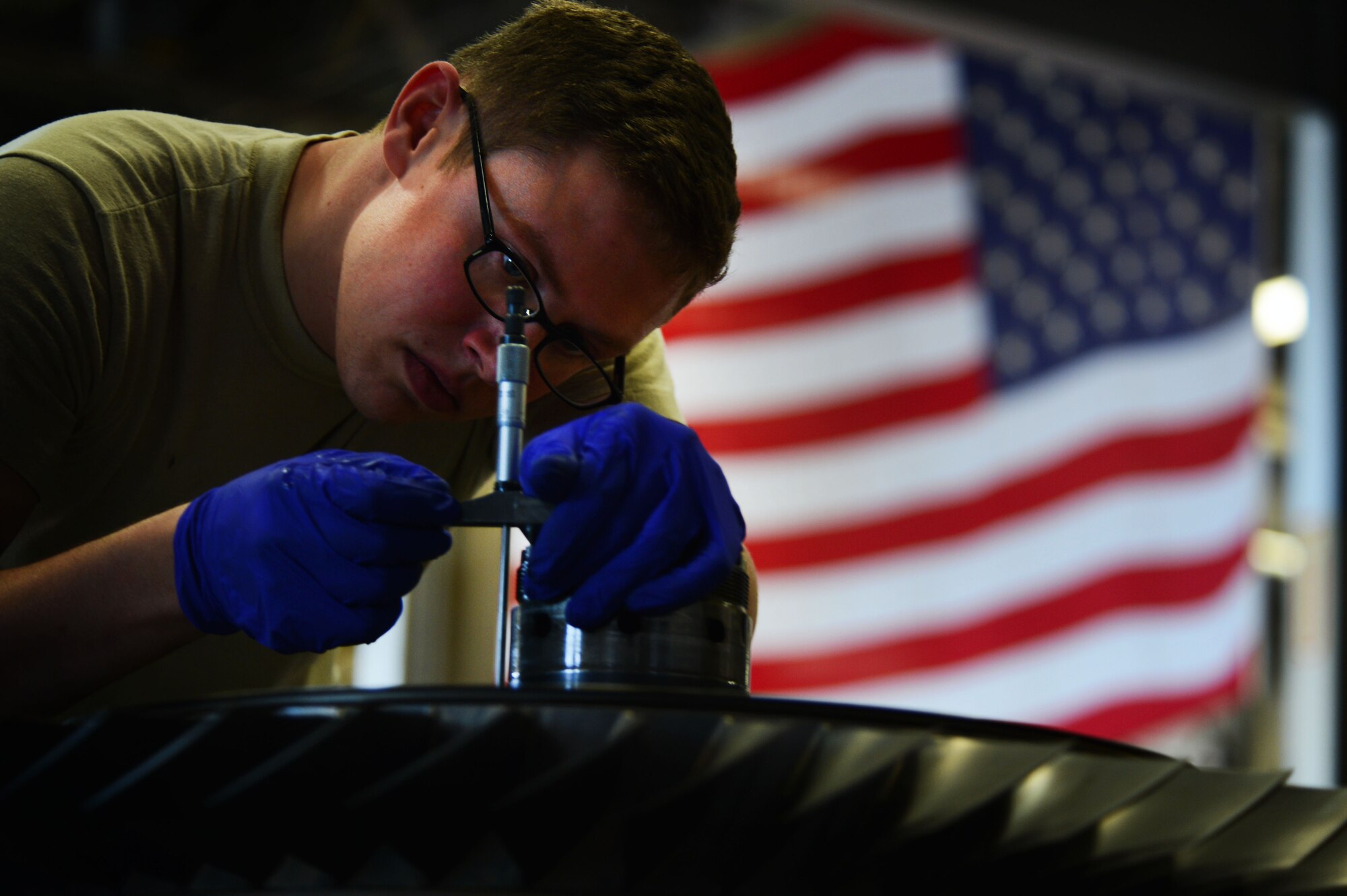 U.S. Air Force Senior Airman James Hafner III, 20th Component Maintenance Squadron aerospace propulsion technician, takes a drop measurement of a fan rotor shaft on an F110-General Electric-129 engine during Operational Readiness Exercise Weasel Victory 14-06 at Shaw Air Force Base, S.C., May 6, 2014. Without a properly rotating fan shaft the engine would not be able to meet its maximum fan speed at 8,200 rotations per minute. (U.S. Air Force photo by Airman 1st Class Jensen Stidham/Released)