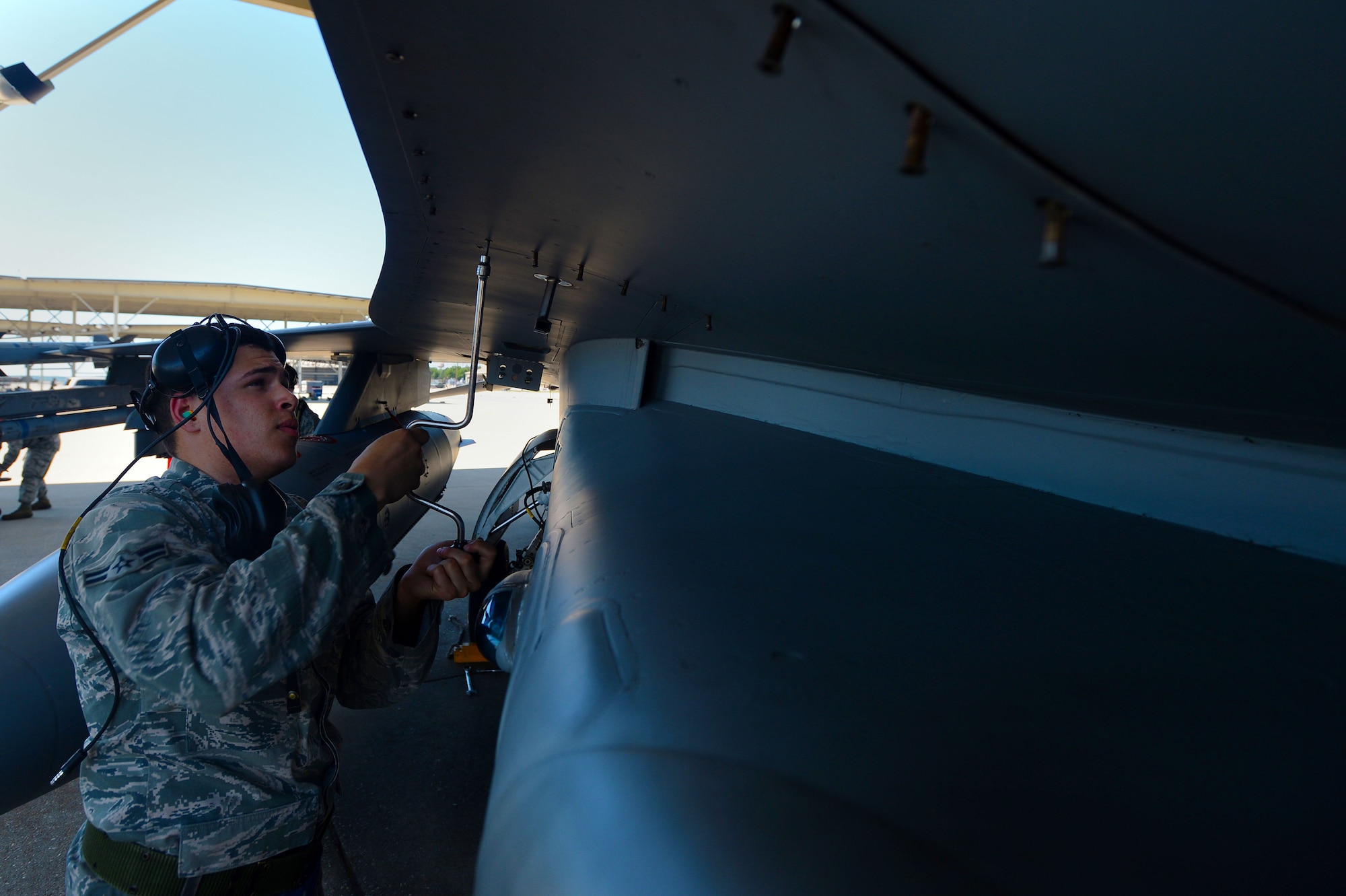 U.S. Air Force Airman 1st Class Anthony Franqui, 20th Aircraft Maintenance Squadron avionics specialist, tightens bolts on an F-16CJ Fighting Falcon during Operational Readiness Exercise Weasel Victory 14-06 at Shaw Air Force Base, S.C., May 5, 2014. While preparing the jet, Franqui quality checked the inside of each panel on the jet to ensure maximum safety while it is in the air. The two-day exercise was held to demonstrate the ability of 20th Fighter Wing Airmen effectively generate and employ aircraft, exercise self-aid and buddy care, and demonstrate the ability to defend the base. (U.S. Air Force photo by Airman 1st Class Jensen Stidham/Released)