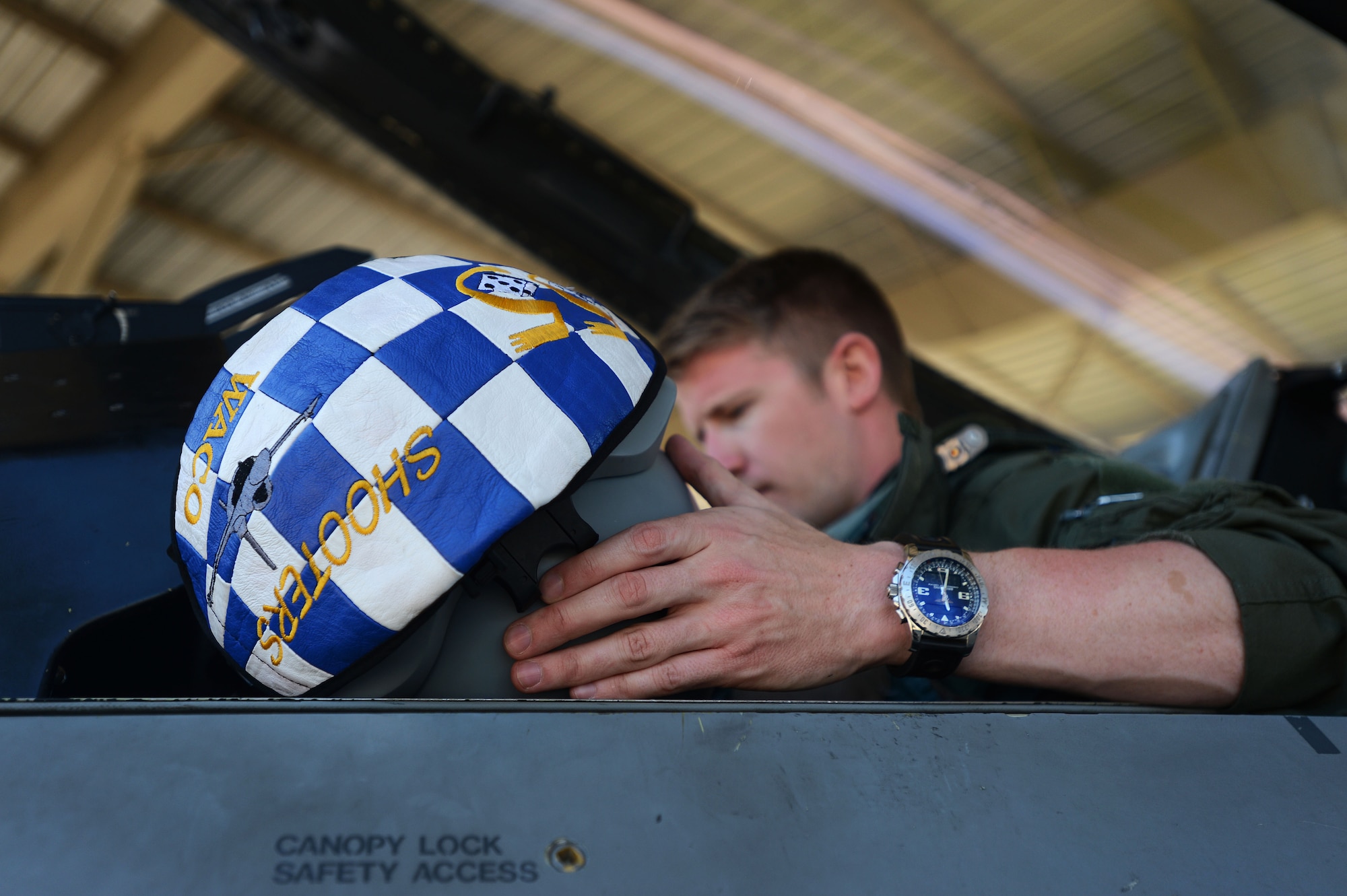 U.S. Air Force Capt. Taylor Tally, 55th Fighter Squadron pilot, holds his helmet while performing pre-flight checks in an F-16CJ Fighting Falcon during Operational Readiness Exercise Weasel Victory 14-06 at Shaw Air Force Base, S.C., May 5, 2014. The two-day exercise was held to demonstrate the ability of 20th Fighter Wing Airmen effectively generate and employ aircraft, exercise self-aid and buddy care, and demonstrate the ability to defend the base. (U.S. Air Force photo by Airman 1st Class Jensen Stidham/Released)