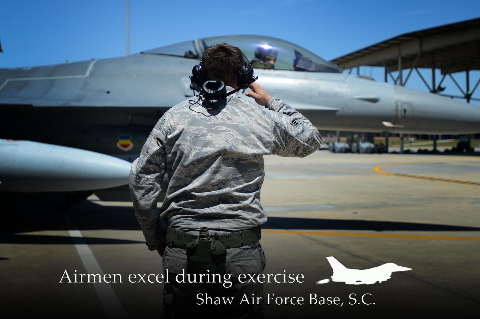 U.S. Air Force Senior Airman Ethan Edmisten, 20th Aircraft Maintenance Squadron assistant dedicated tactical aircraft maintainer assigned to the 55th Aircraft Maintenance Unit, renders a salute as a pilot taxis to the runway during an operational readiness exercise at Shaw Air Force Base, S.C., May 5, 2014. (U.S. Air Force photo illustration by Airman 1st Class Jensen Stidham/Released)