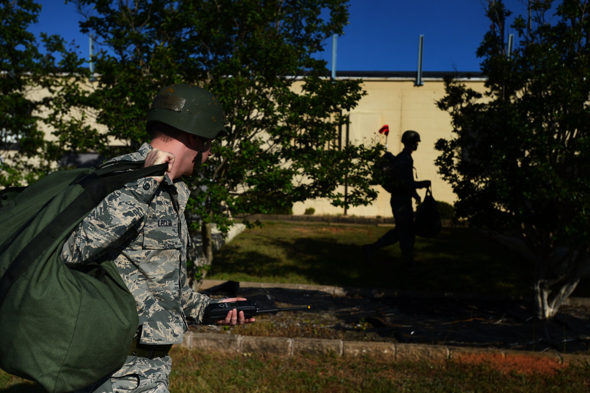 U.S. Air Force Staff Sgt. Thomas Leclair, 20th Component Maintenance Squadron avionics intermediate shop team leader, looks at Airman 1st Class Jonathan Pulaski, 20th CMS avionics intermediate shop team member, while conducting a performance and accountability report sweep during Operational Readiness Exercise Weasel Victory 14-06 at Shaw Air Force Base, S.C., May 5, 2014. Foreign objects, shell casings, damage, and casualties are a few scenarios that could have been simulated during a PAR sweep. (U.S. Air Force photo by Airman 1st Class Jensen Stidham/Released)