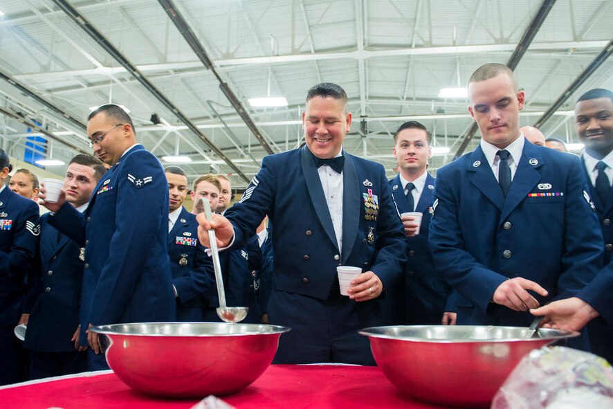 U.S. Air Force Senior Master Sgt. Roderick Vega, 23d Wing deputy inspector general, serves cups of ‘grog’ during a dining-in at Moody Air Force Base, Ga., May 2, 2014. The grog bowl is a mix of juices and other ingredients such as salt, sugar and gummy worms, and is meant as punishment for ignorance of custom and tradition. (U.S. Air Force photo by Airman 1st Class Ryan Callaghan/Released)