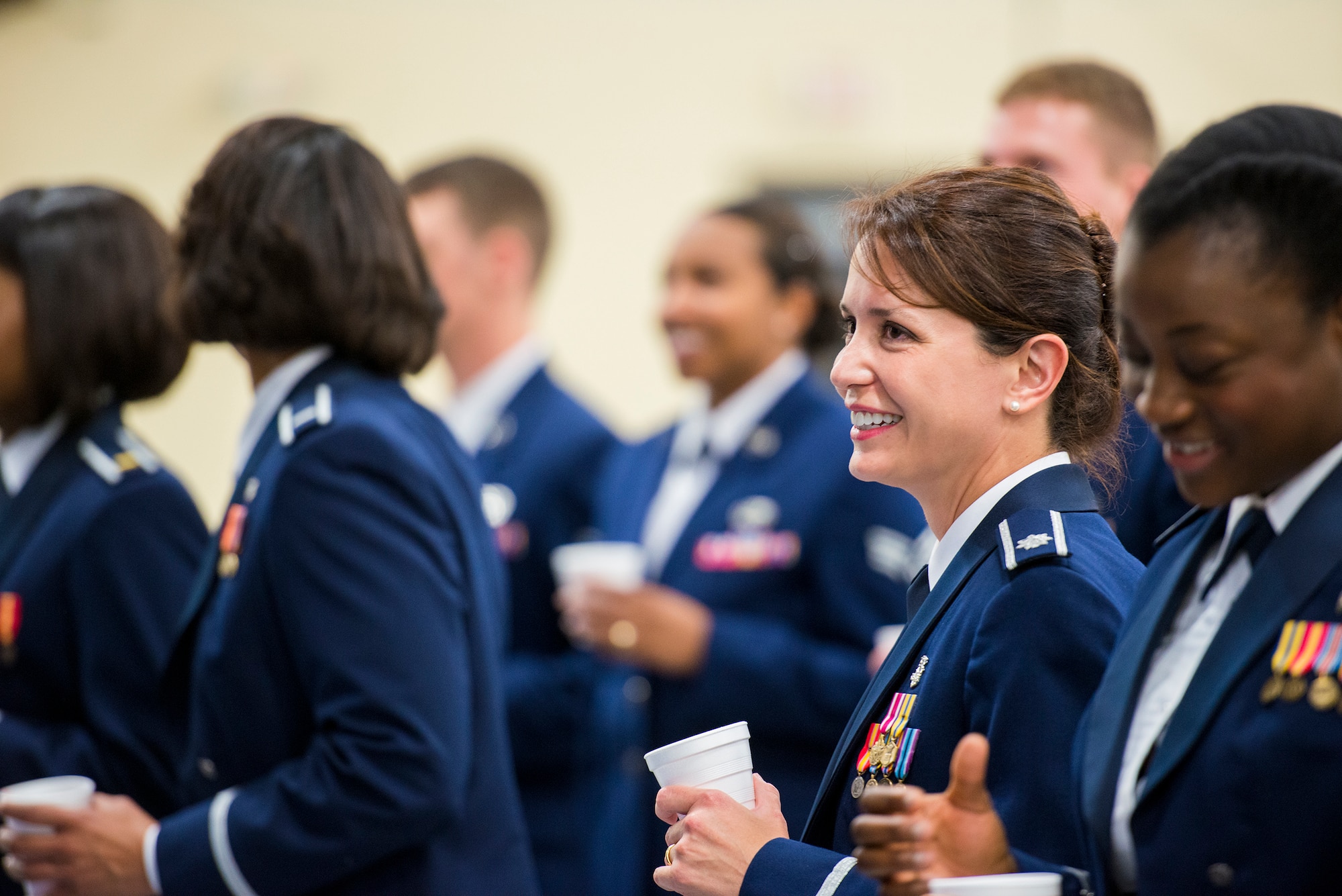 U.S. Air Force Lt. Col. Jackie Day, 23d Mission Support Group, smiles before a toast during a dining-in at Moody Air Force Base, Ga., May 2, 2014. Toasting is a universal custom intended as a courtesy to the person being honored and is a common occurrence at Air Force dining-ins. (U.S. Air Force photo by Airman 1st Class Ryan Callaghan/Released)