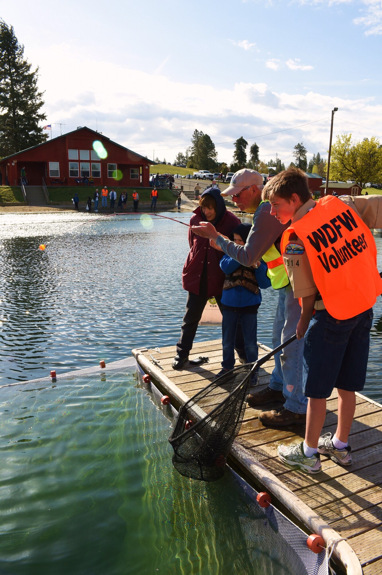 Boy Scout Tristan Reynolds, son of Marine Corps. 1st Sgt. Jason Reynolds prepares a net for fish retrieval during Fairchild Air Force Base Clear Lake’s opening day event in Cheney, Wash., April 26, 2014. Clear Lake Recreation Area provides fishing, water skiing, swimming and boating for off-duty Fairchild Air Force Base personnel, including active duty, retired military, National Guard, active members of the Reserves, Department of Defense civilian employees and family members. Tristan attends 8th grade at Medical Lake Middle School and is a Fairchild resident. (Courtesy photo by Jerry Rowles)