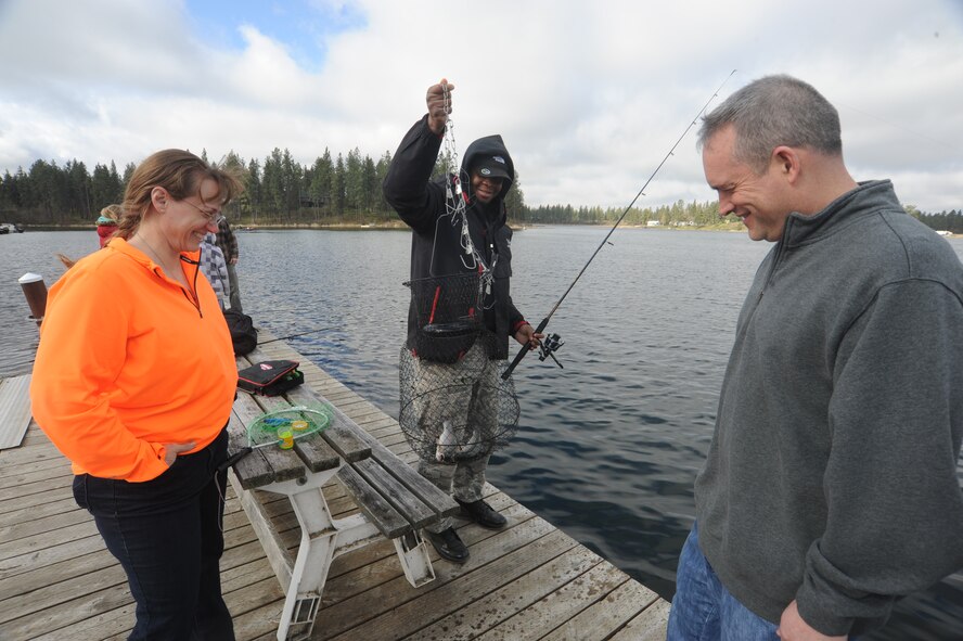 Col. Brian Newberry and Chief Master Sgt. Wendy Hansen take note of a rainbow trout captured by Tech. Sgt. Omar Jones during Fairchild Air Force Base Clear Lake Resort’s opening day in Cheney, Wash., April 26, 2014. Fishing started at midnight that day. Newberry is the 92nd Air Refueling Wing commander and Hansen is the 92nd ARW command chief. Jones is a member of the 92nd Maintenance Squadron. (U.S. Air Force photo by Airman 1st Class Sam Fogleman/Released)