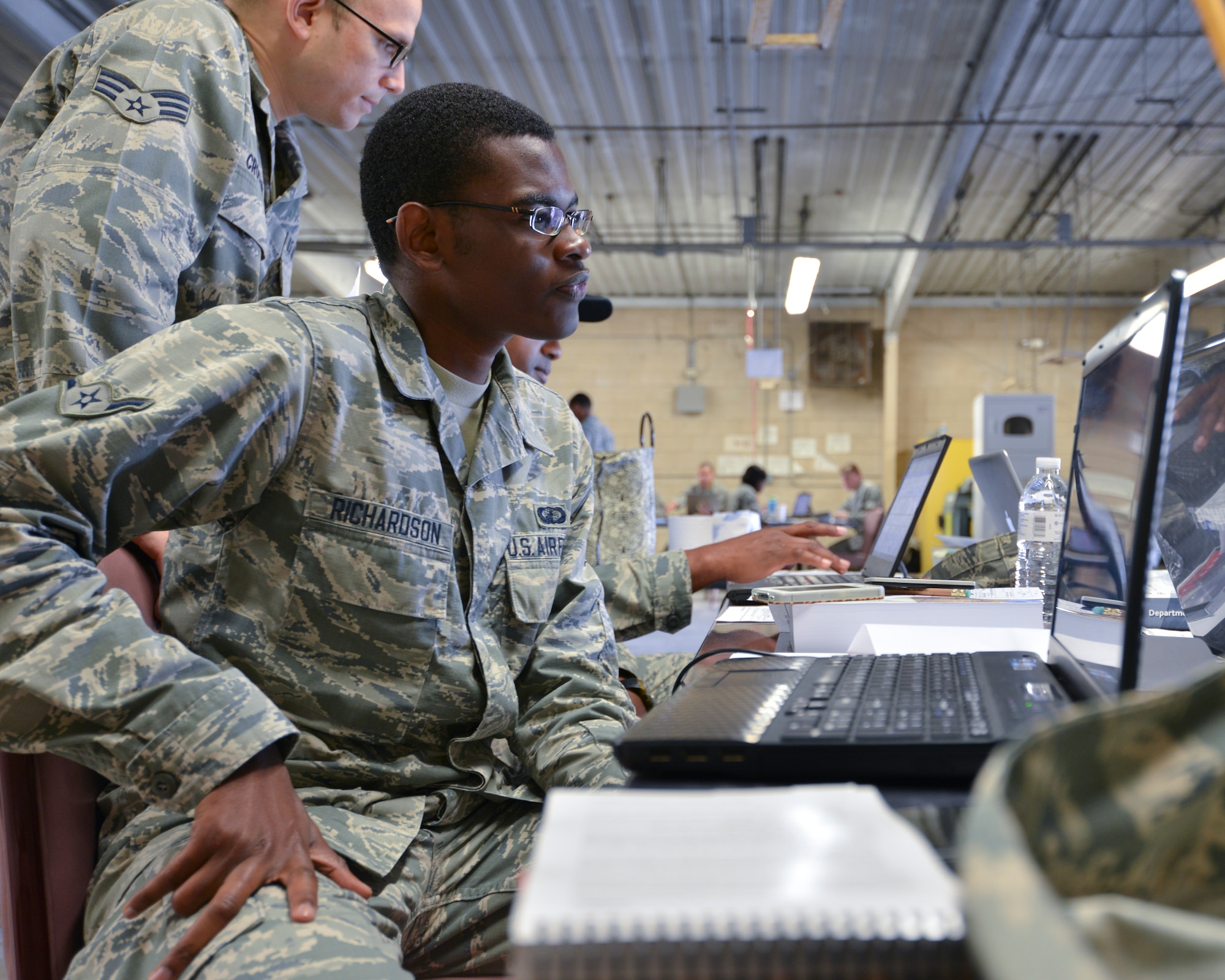 Airman 1st Class Carl Richardson, 325th Contracting Squadron contracting specialist, reviews Defense Department guidelines for acquisition of materials necessary for the establishment of a new operating base during an exercise May 30 at Tyndall. The exercise was a joint effort between the 325th Contracting Squadron and the 722nd Enterprise Sourcing Squadron to give Airmen from all levels of experience a chance to work in a simulated deployment zone. (U.S. Air Force photo by Tech. Sgt. Javier Cruz)