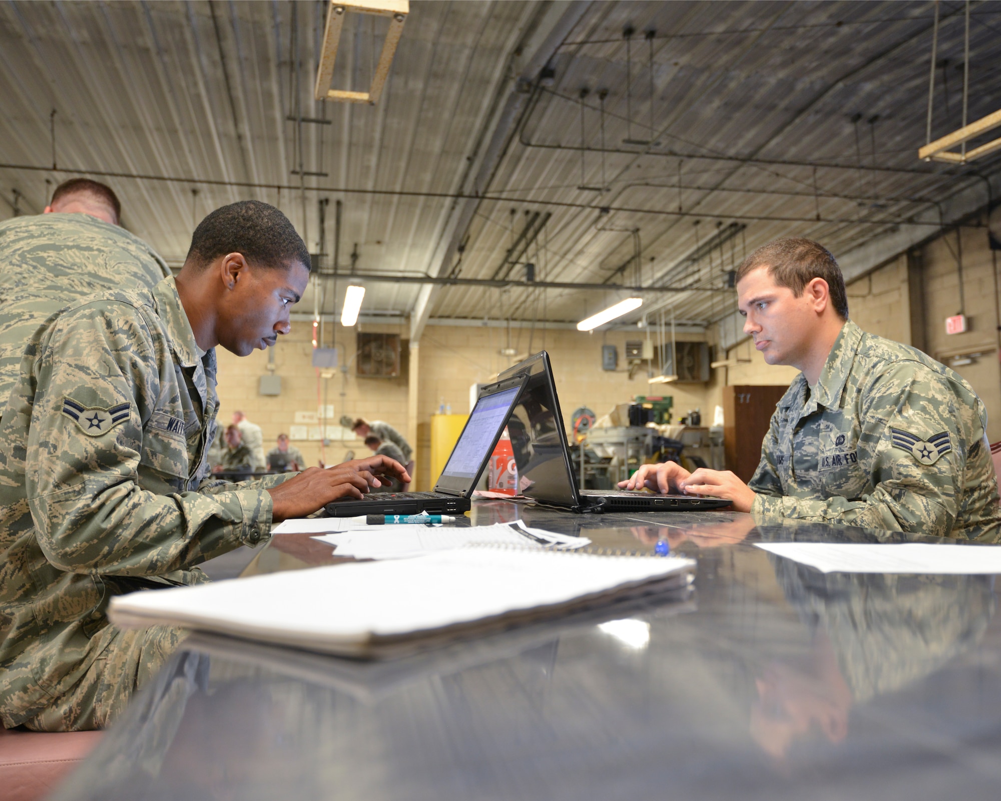Airman 1st Class Mark Waithe, 772nd Enterprise Sourcing Squadron contracting specialist (left) and Senior Airman Codey Williams 325th Contracting Squadron contracting specialist (right), work together to secure necessary raw materials, critical supplies and general services for a simulated deployment zone May 30 at Tyndall’s Golf Course. The exercise was a joint effort between the 325th CONS and the 722nd ESS, to give Airmen from all levels of experience a chance to work in a simulated deployment zone. (U.S. Air Force photo by Tech. Sgt. Javier Cruz) 
