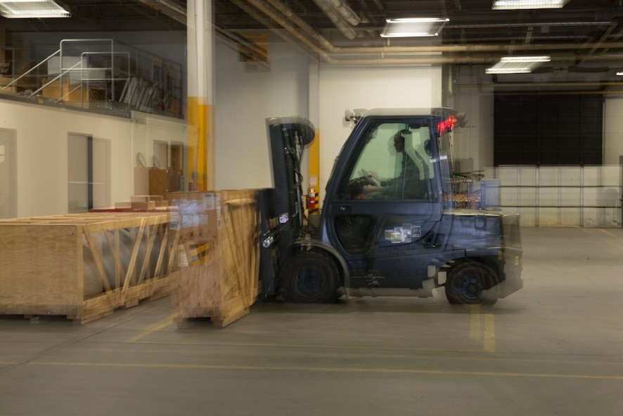 Airmen from the 5th Logistics Readiness Squadron traffic management office assemble crates and label cargo for shipment at Minot Air Force Base, N.D., April 30, 2014. TMO is responsible for packaging and shipping furnished goods to other bases around the world. In addition to receiving and shipping Airmen’s household goods, TMO also assists with the shipment and packaging of mission essential parts and components. (U.S. Air Force photo/Airman 1st Class Sahara L. Fales)