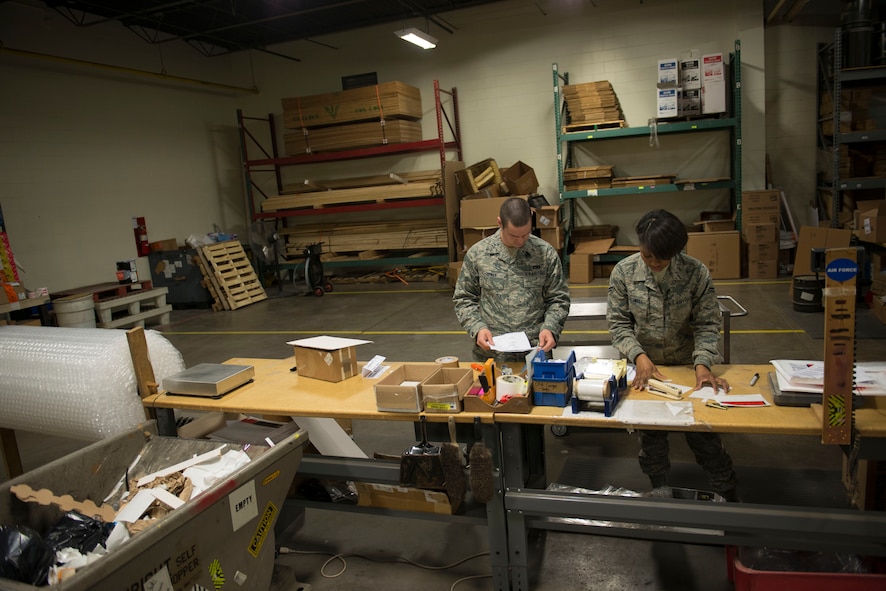 Airmen from the 5th Logistics Readiness Squadron traffic management office assemble crates and label cargo for shipment at Minot Air Force Base, N.D., April 30, 2014. TMO is responsible for packaging and shipping furnished goods to other bases around the world. In addition to receiving and shipping Airmen’s household goods, TMO also assists with the shipment and packaging of mission essential parts and components. (U.S. Air Force photo/Airman 1st Class Sahara L. Fales)