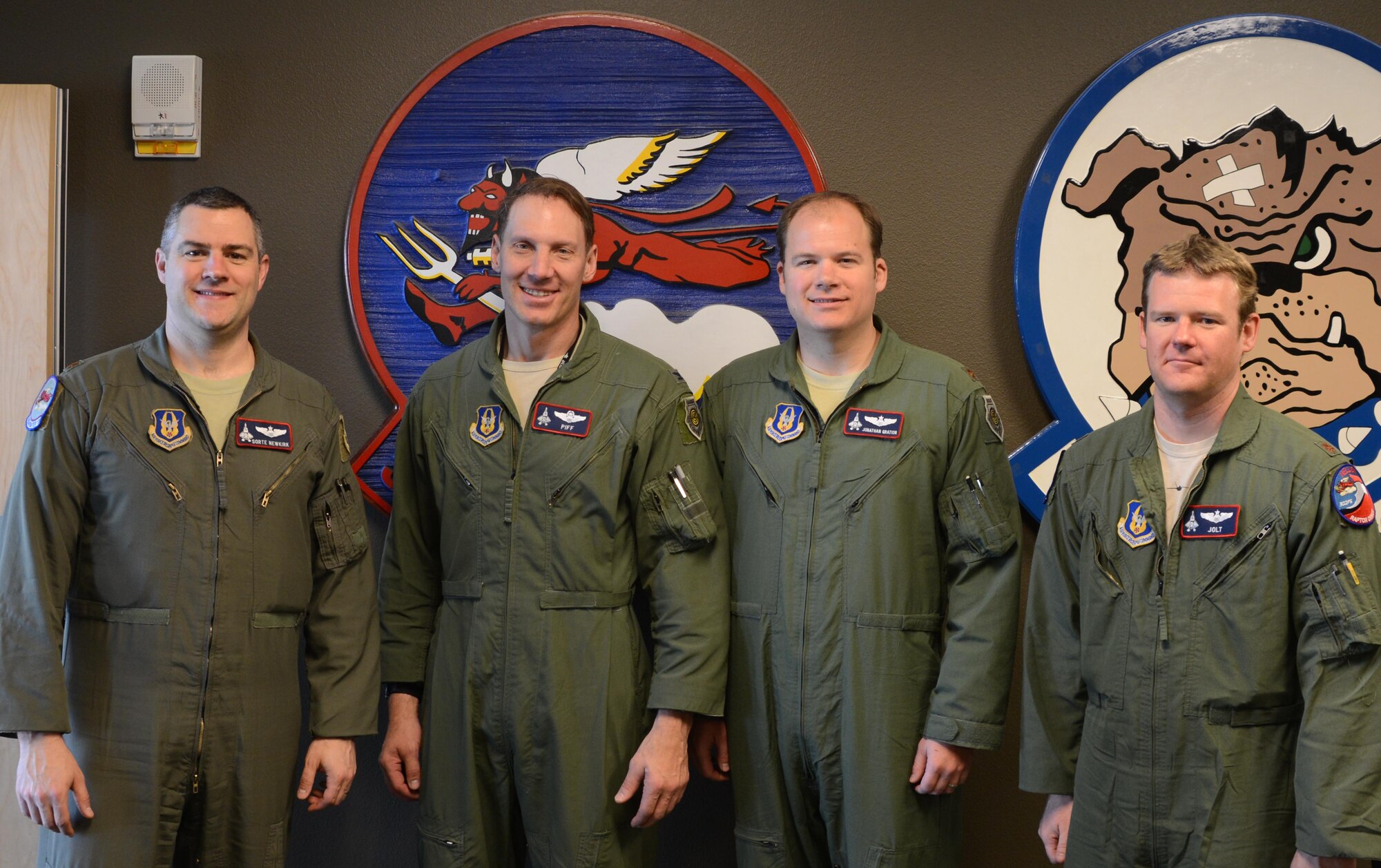 Maj. Chad Newkirk, Col. David Piffarerio, Maj. Jonathan Gration, and Maj. Ryan Pelkola, F-22 pilots from the 477th Fighter Group, are interviewed by a local television station prior to flying the most experienced four-ship flight in the history of the F-22. (U.S. Air Force Photo/ Tech. Sgt. Dana Rosso)