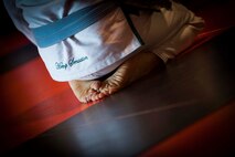A member of the Minot Brazilian Jiu-Jitsu team performs breathing techniques at Calavera Martial Arts and Boxing club in Minot, N.D., April 21, 2014. The controlled breathing is a way to calm the mind and body before a vigorous training session. (U.S. Air Force photo/Airman 1st Class Apryl Hall)