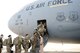 Servicemembers board a C-17 bound for Afghanistan. After more than a decade of operations at Manas, Kyrgystan, the Romanian location has become the U.S. military’s main air hub for passengers and cargo into and out of Afghanistan.