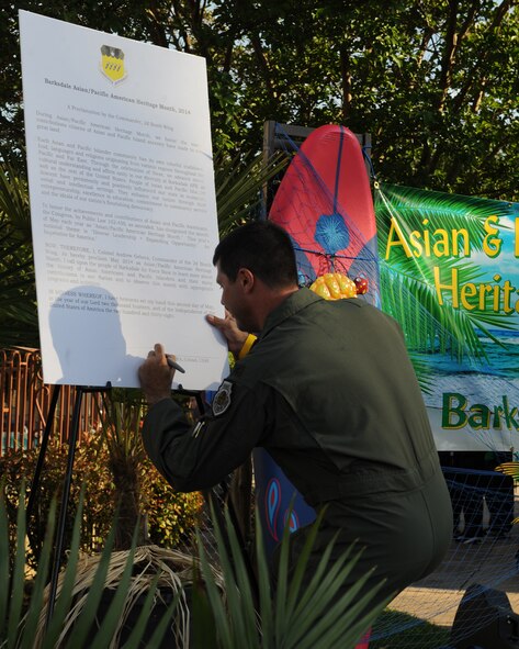 Col. Andrew Gebara, 2nd Bomb Wing commander, signs a proclamation for the Asian-Pacific Heritage-Fest Luau on Barksdale Air Force Base, La., May 2, 2014. Around 3,000 people attended the luau to see exotic performances and taste ethnic foods from all over Asia and the Pacific. (U.S. Air Force photo/Senior Airman Benjamin Gonsier)