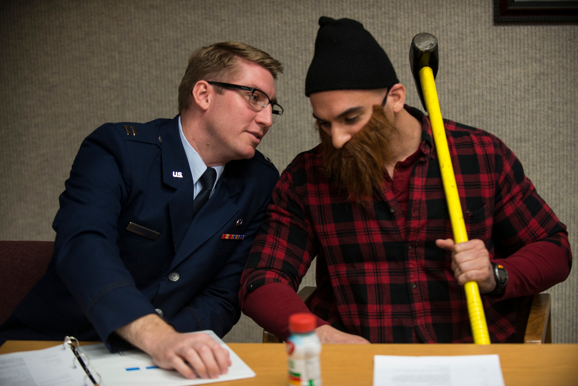 Lt. Col. Jorge Jimenez, 5th Comptroller Squadron commander, consults his lawyer during the mock trial of “Paul Bunyan vs. the state” during the 5th Bomb Wing Legal Office Law Day celebration, May 1, 2014. Jimenez, who was playing the role of Paul Bunyan, participated in teaching a sixth grade class from North Plains Elementary School the importance of the legal system. (U.S. Air Force photos/Airman 1st Class Lauren Pitts)