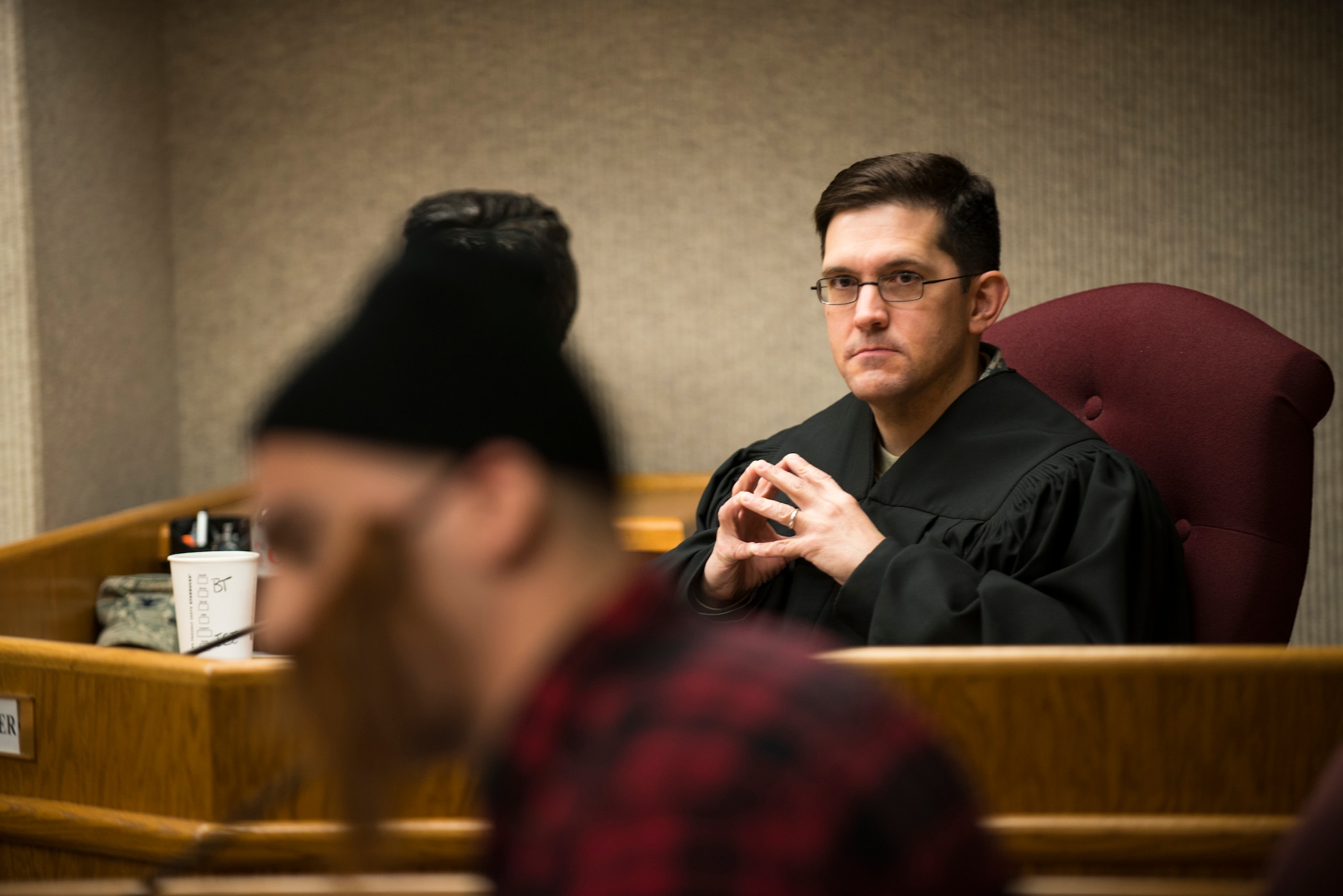 Col. William Mazzeno, 5th Mission Support Group commander, looks on as the Judge during a mock trial at Minot Air Force Base, N.D., May 1, 2014. During the 5th Bomb Wing Legal Office Law Day celebration, the Legal Office preformed a court hearing for a sixth grade class from North Plains Elementary School to teach the students about legal procedures. (U.S. Air Force photos/Airman 1st Class Lauren Pitts) 