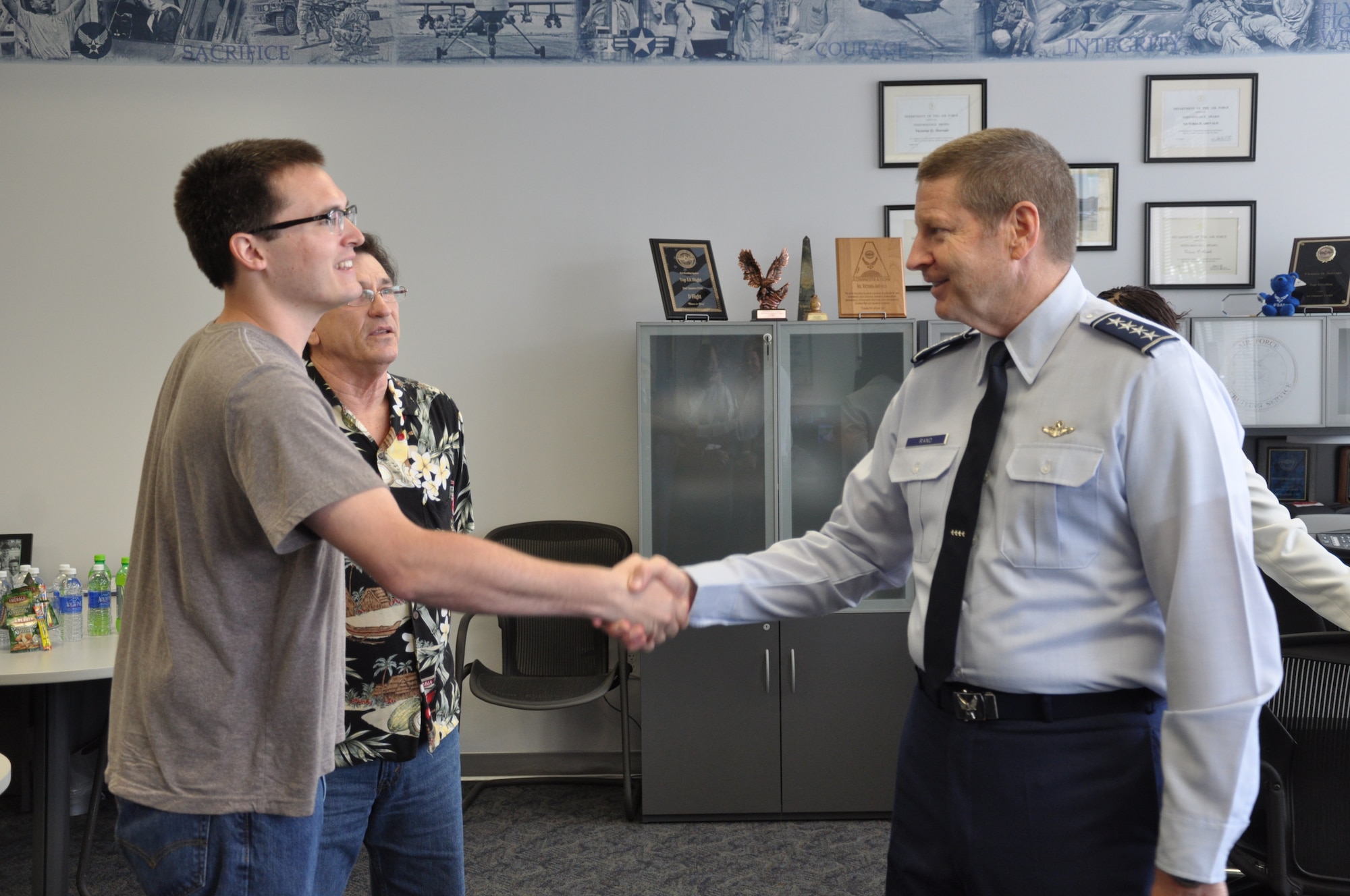 Gen. Robin Rand, commander of Air Education and Training Command (right), greets an Air Force applicant during his visit to the 341st Recruiting Squadron hub in Austin, Texas, April 21. The hub consolidates recruiting offices assigned to the Austin area to improve customer service and assist recruiters with their career development. (U.S. Air Force photo/Capt. Lauren Hale)