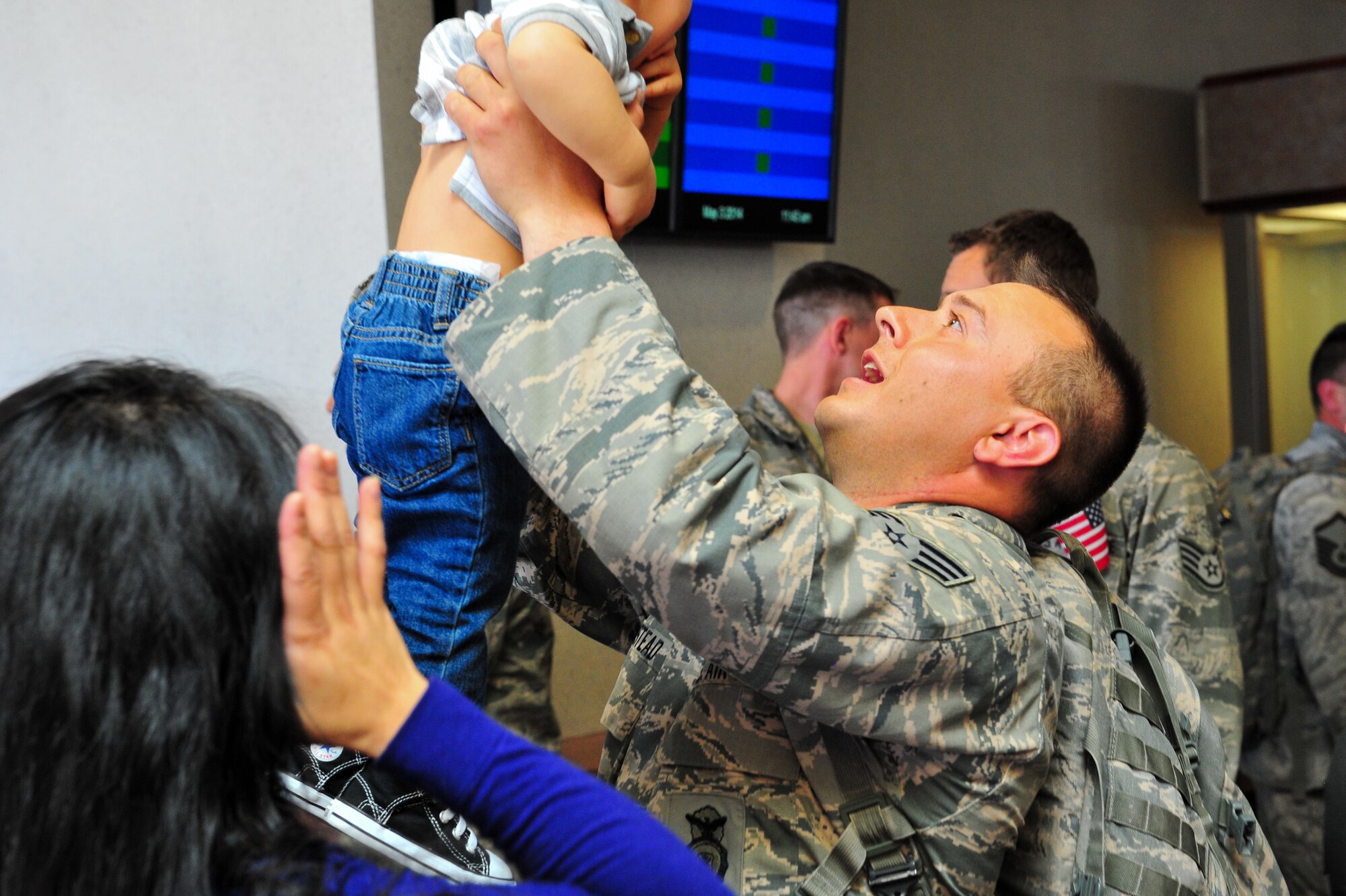 Air Force Reserve Senior Airman Levi Milstead raises his son with excitement during a homecoming from Southwest Asia May 3, 2014, at the Colorado Spring Airport in Colorado Springs, Colo. Milstead and nearly 15 other AF Reservists assigned to the 310th Security Forces Squadron provided integrated base defense, physical security and antiterrorism and force protection measures on behalf of U.S. and allied personnel at the Manas Transit Center in the Kyrgyz Republic.
(U.S. Air Force photo/Tech. Sgt. Nicholas B. Ontiveros)