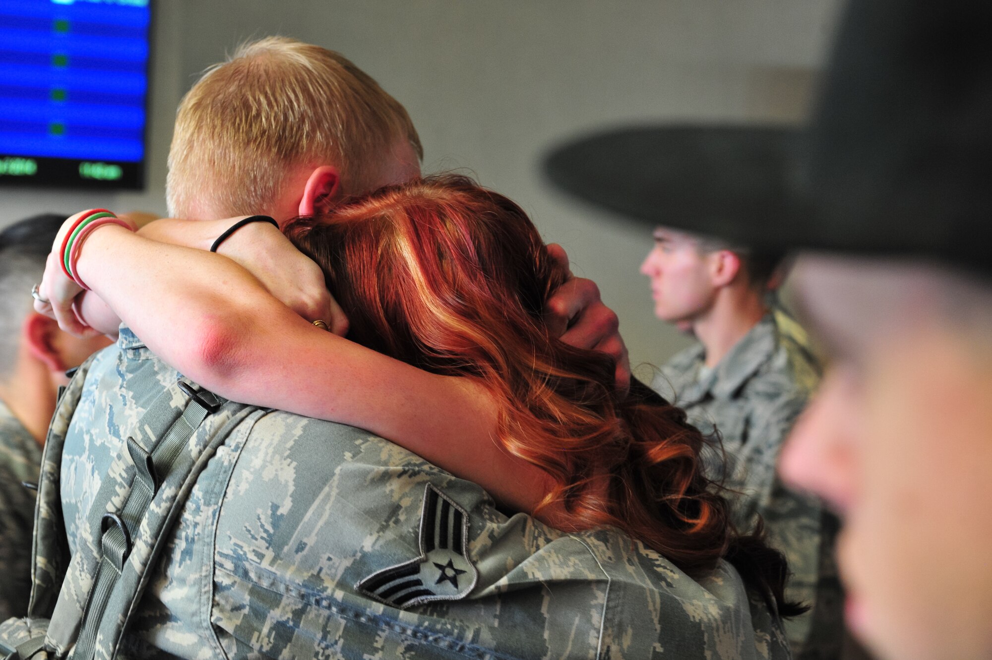 An Air Force Reserve Security Forces Airman is warmly greeted as he returns from Southwest Asia May 3, 2014, at the Colorado Spring Airport in Colorado Springs, Colo. Nearly 15 AF Reservists assigned to the 310th Security Forces Squadron redeployed from the Manas Transit Center in Kyrgyzstan where they provided integrated base defense, physical security and antiterrorism and force protection measures on behalf of U.S. and allied personnel. (U.S. Air Force photo/Tech. Sgt. Nicholas B. Ontiveros)