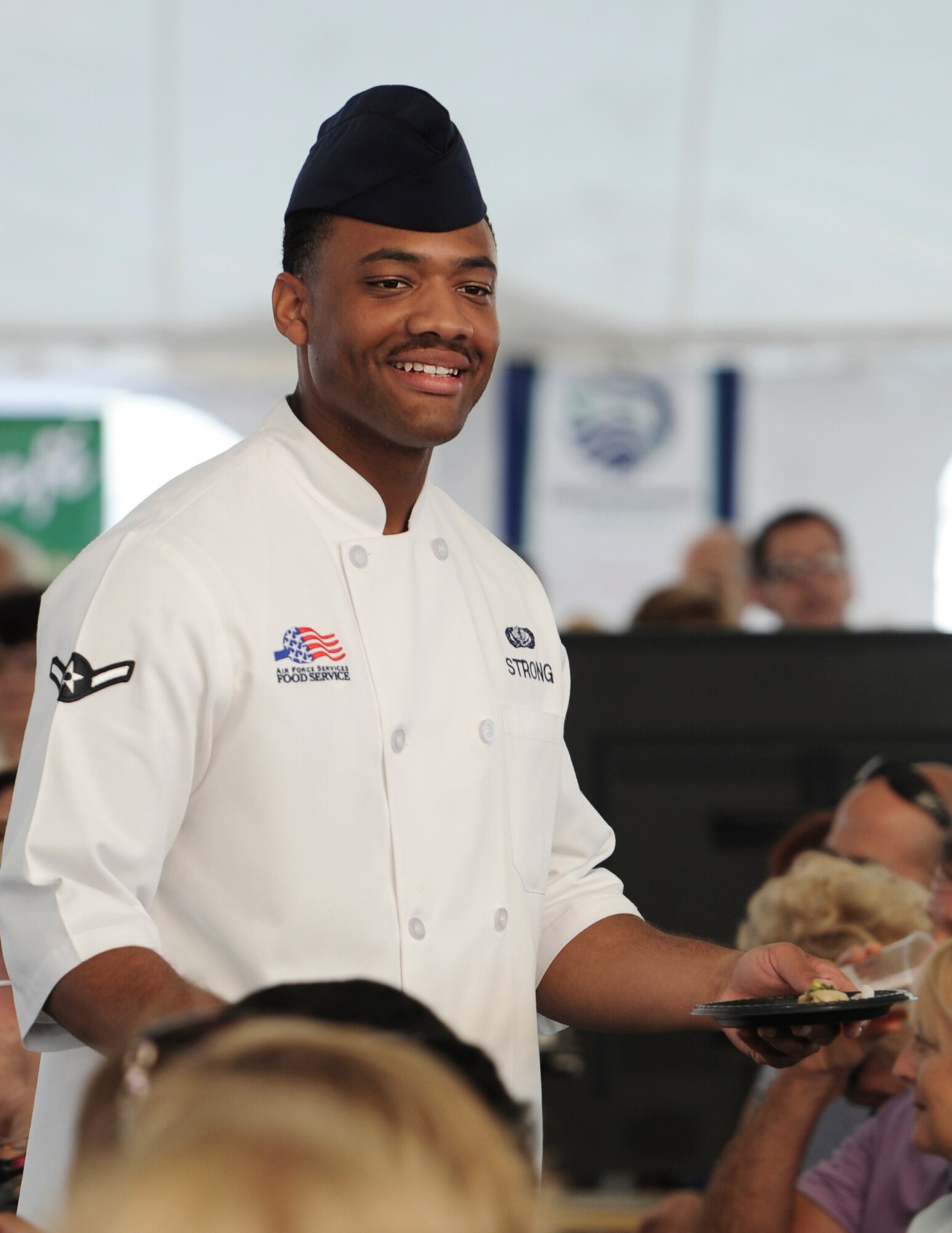 Airman Gary Strong, 1st Special Operations Force Support Squadron food service specialist, delivers food at the Taste of Navarre in Navarre, Fla., May 4, 2014. (U.S. Air Force photo/Senior Airman Christopher Callaway) 