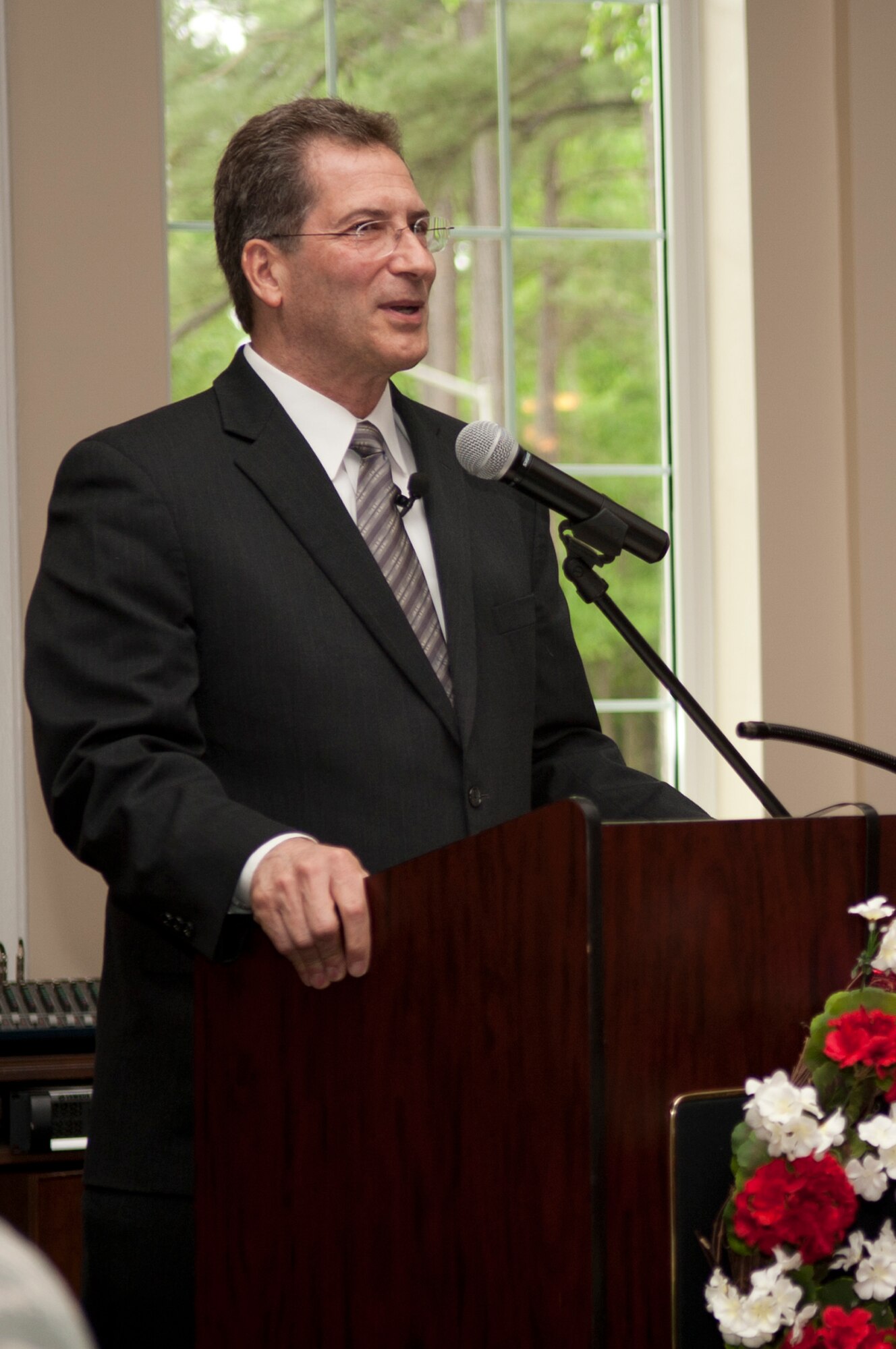 Dr. Glenn Schiraldi, University of Maryland School of Public Health psychology professor and guest speaker, talks about spiritual resilience during the National Prayer luncheon, May 2, 2014, at Seymour Johnson Air Force Base, N.C. Schiraldi shared his accounts of a five-year period where he traveled and interviewed multiple combat survivors and prisoners of war about resiliency. (U.S. Air Force photo/Airman 1st Class Shawna L. Keyes)          