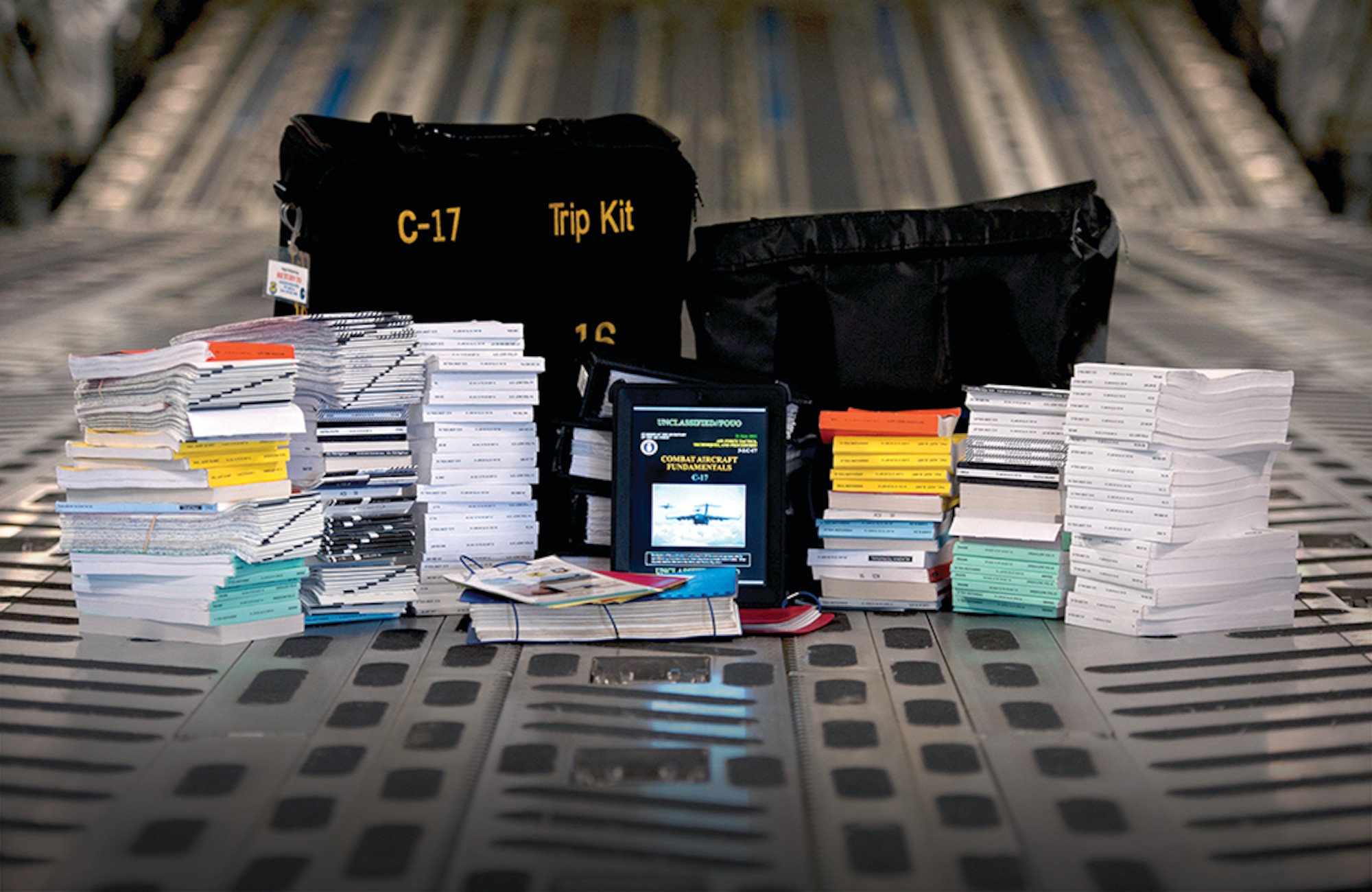 An electronic flight bag sits in the middle of all the
paper flight manuals and products it will replace.