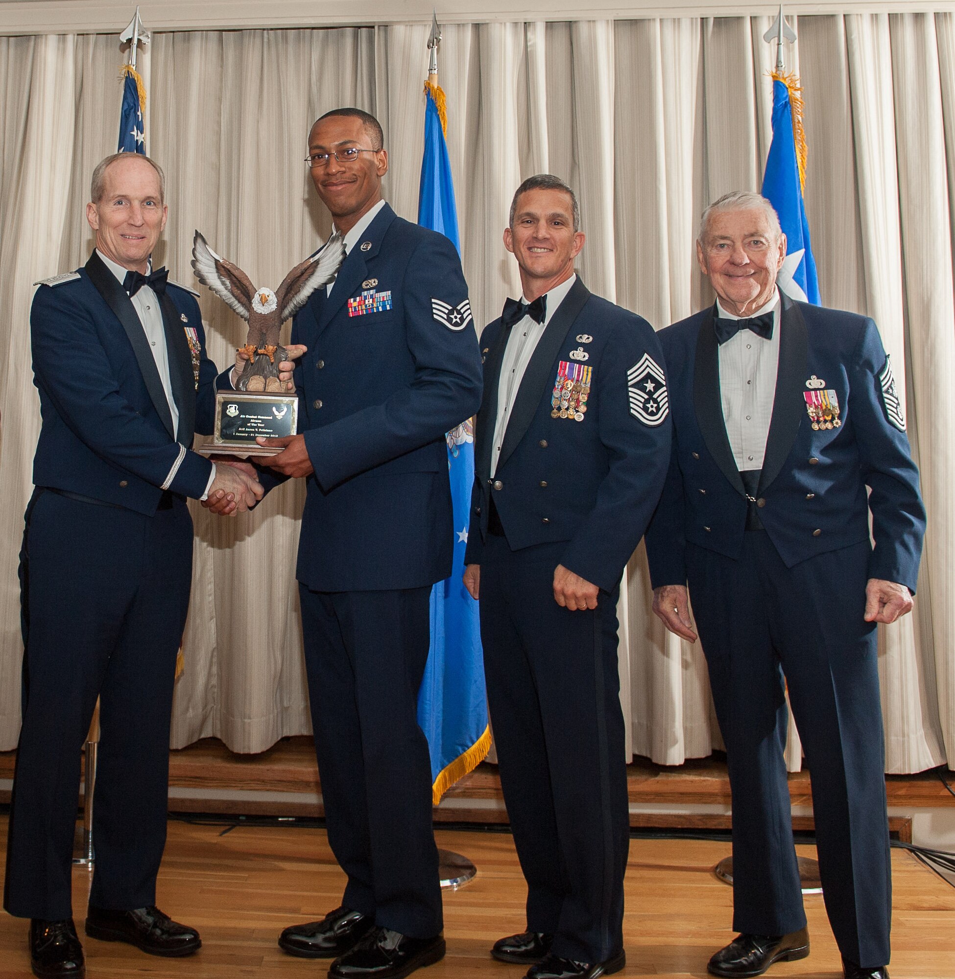 Senior Airmen Aaron T. Feliciano’s Outstanding Airman of the Year award is accepted on his behalf, while he is deployed, at the Langley Club on Joint Base Langley-Eustis 23 April. (U.S. Air Force photo by Sachel Simone/Released)