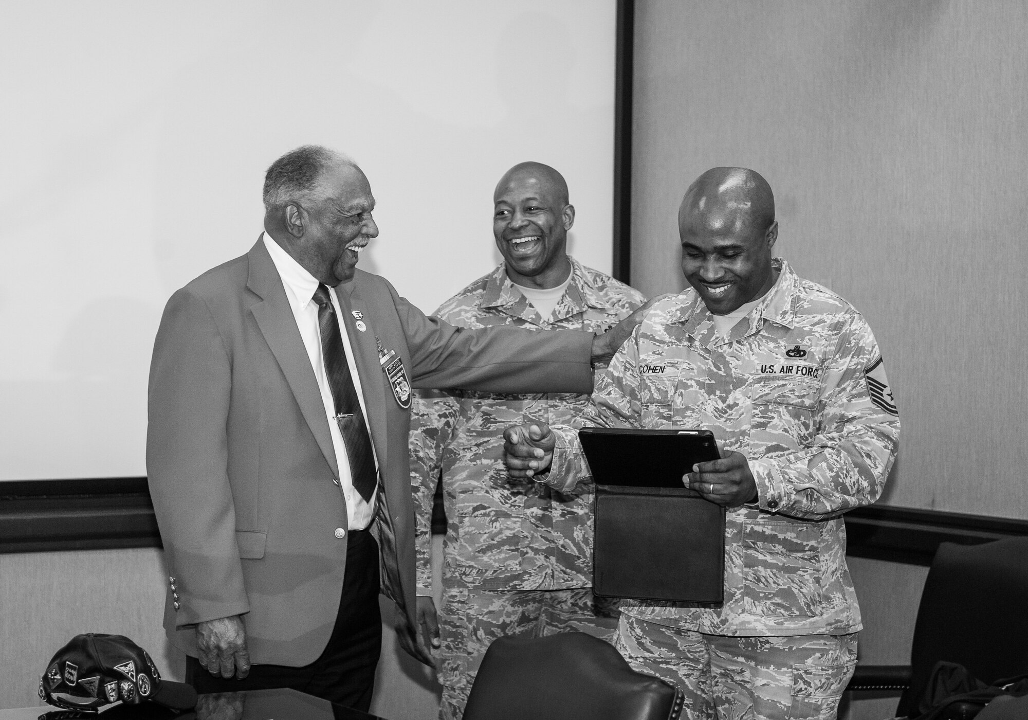 Master Sgt. Christopher Cohen, 20 FSS Honor Guard superintendent at Shaw AFB, S.C., shares a laugh with former Tuskegee Airman Harry Quinton. Cohen met Quinton as part of the awards banquet for winning a spot as one of Air Combat Command’s Outstanding Airman of the Year. (U.S. Air Force photo by Sachel Seabrook /Released)