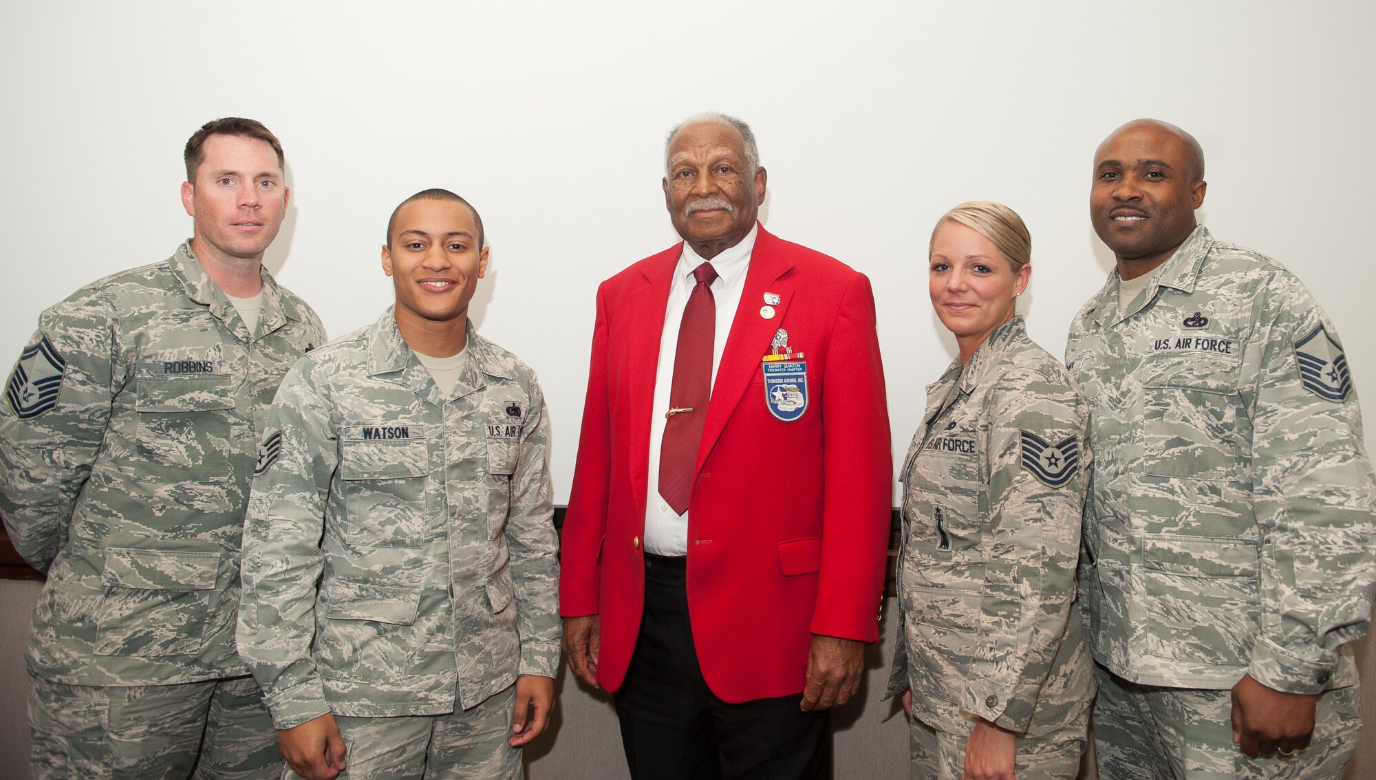 The Air Combat Command Outstanding Airmen of the Year stand with former Tuskegee Airman Harry Quinton. (U.S. Air Force photo by Sachel Seabrook/Released)