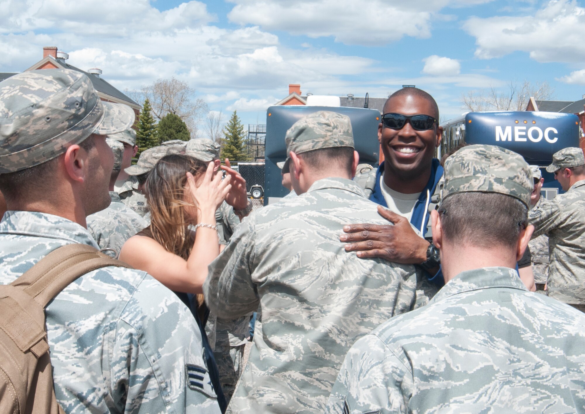 Wingmen surround and greet Tech. Sgt. Waleed Jones, 90th Civil Engineer Squadron Heating, Ventilation and Air Conditioning, outside Building 328 on F.E. Warren Air Force Base, Wyo., as they welcome him back from his six-month deployment to Southwest Asia May 2, 2014. (U.S. Air Force photo by Airman 1st Class Jason Wiese)