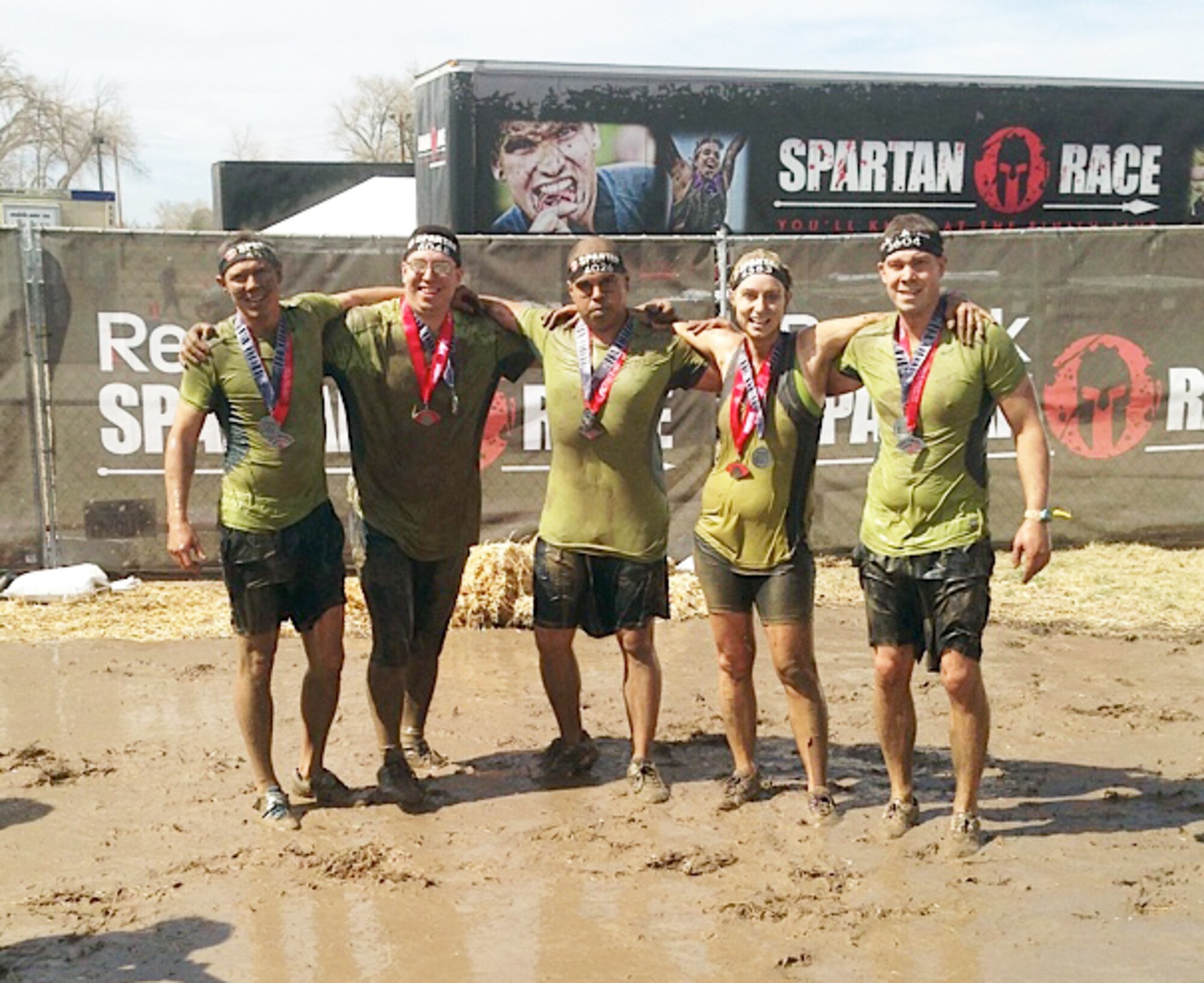 Pictured after completing a grueling 4.5-mile course as a team in 2 hours, 5 minutes are 1st Lt. Jesse Gilbert, Master Sgt. Zachery Mleko, Louis Deanda, Master Sgt. Rachel Forman, and Staff Sgt. Derek Butler.  They participated in a Spartan Race held May 3, 2014, at Fort Carson, Colo. A Spartan Race is an obstacle course race designed to test resilience, stamina, quick decision making skills, and the ability to laugh in the face of adversity. (Courtesy photo)