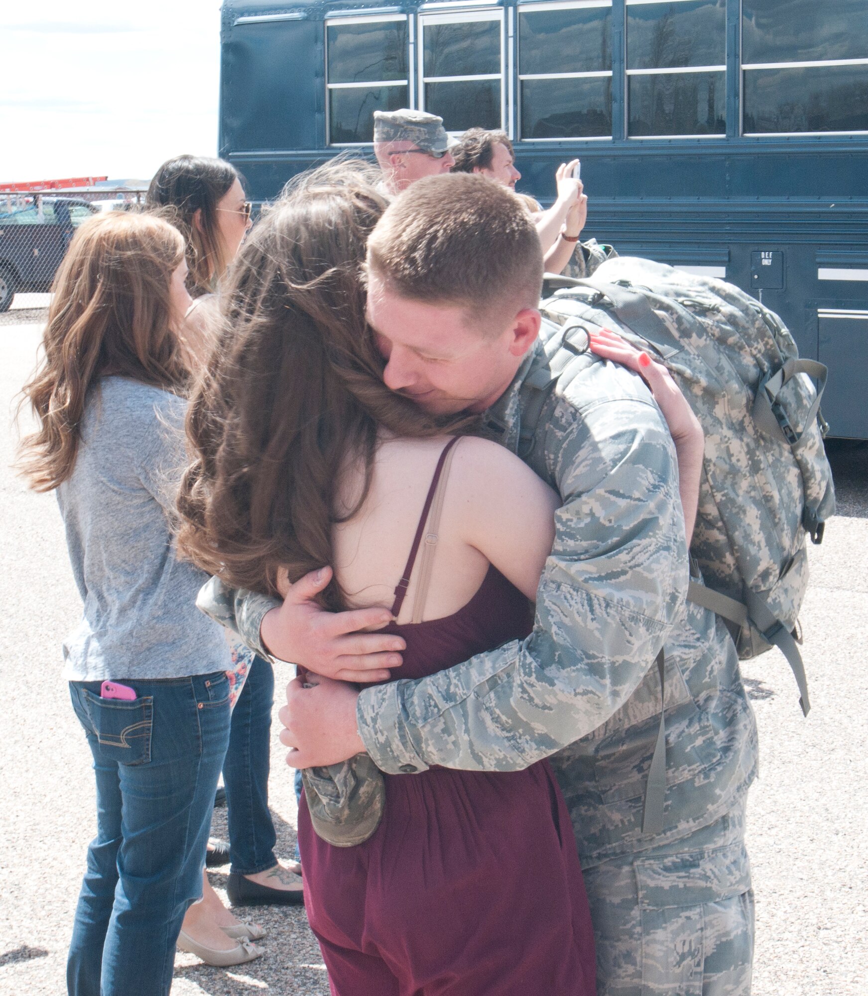 First Lt. Ryan Amedee, 90th Civil Engineer Squadron , embraces his wife Nicole, outside Building 328 on F.E. Warren Air Force Base, Wyo., upon his return from a six-month deployment to Southwest Asia May 2, 2014.  (U.S. Air Force photo by Airman 1st Class Jason Wiese)