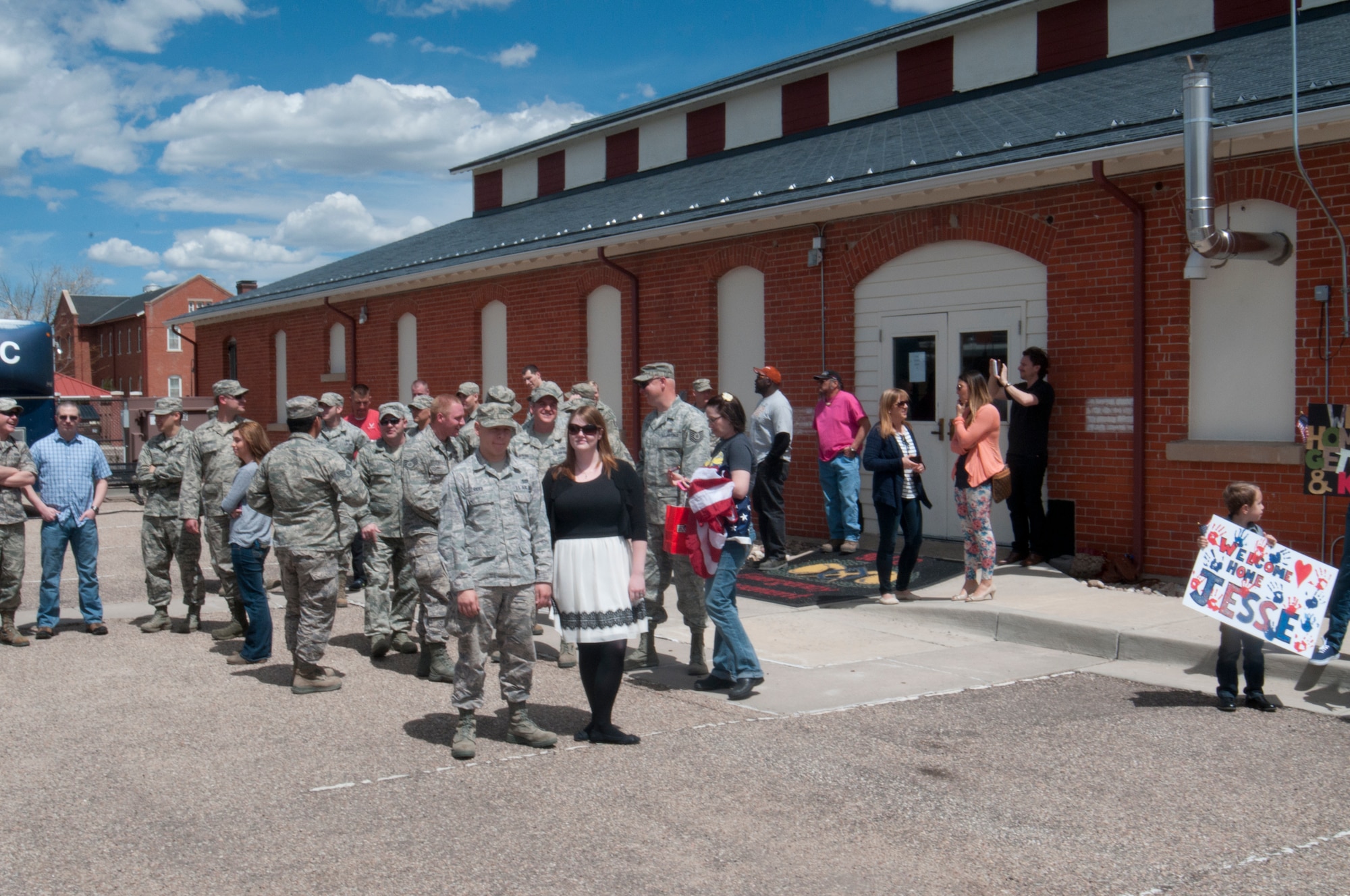 A crowd gathered outside Building 328 on F.E. Warren Air Force Base, Wyo., awaits the return of their friends and loved ones from a six-month deployment to Southwest Asia May 2, 2014. (U.S. Air Force photo by Airman 1st Class Jason Wiese)