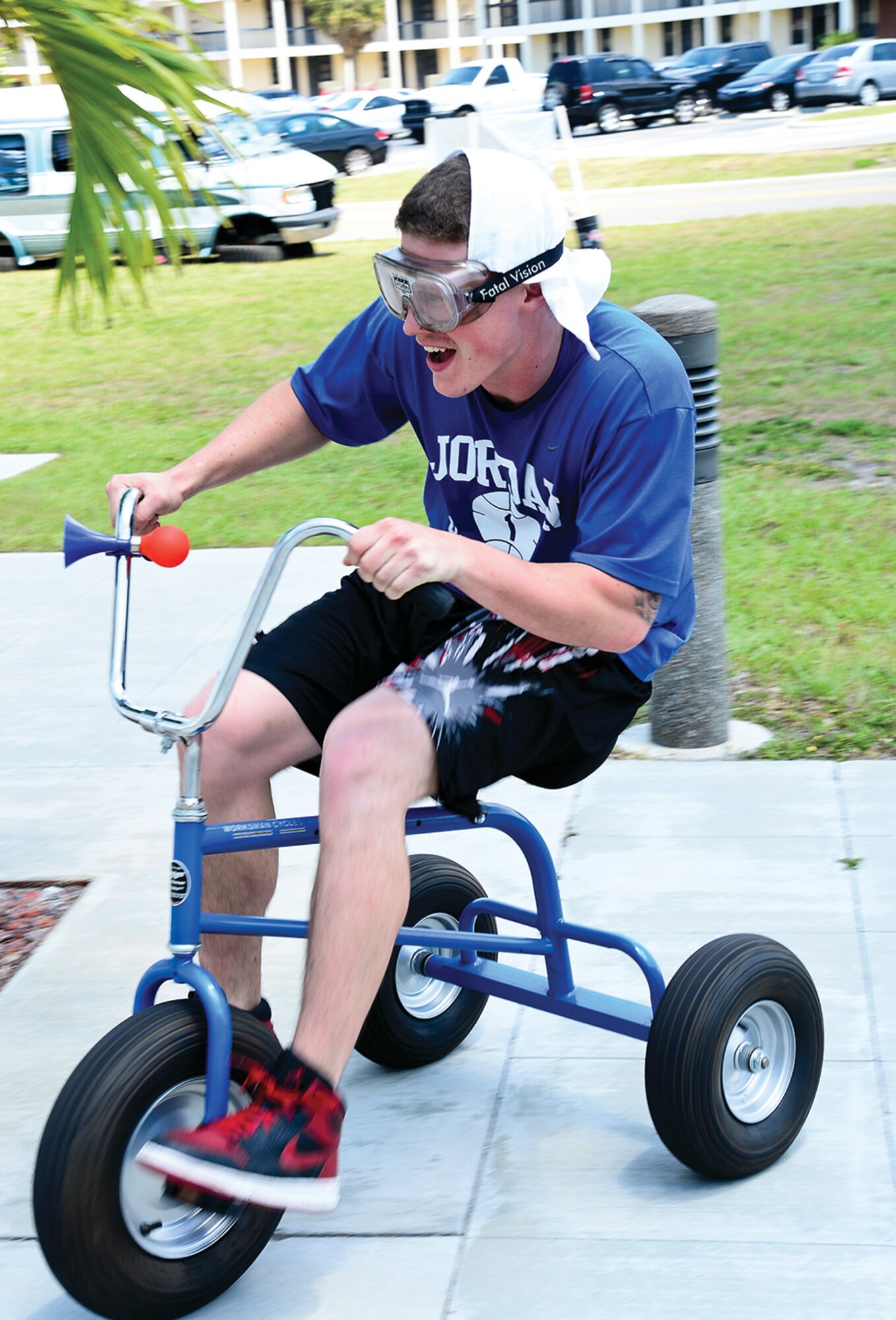 SrA Tyler Treadaway, 6th Maintenance Squadron aircraft metals technician, rides a tricycle while wearing vision impairing goggles during the Critical Days of Summer kick-off event at MacDill AFB, Fla.