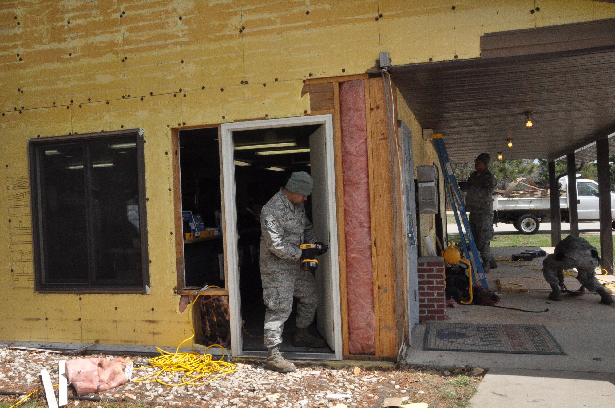 Air Force Reservists with the 433rd Civil Engineer Squadron redo the siding, windows and doors of a Morale Welfare and Recreation building on the west side of Fort McCoy, Wisconsin May 3. The CE unit out of Joint Base San Antonio-Lackland arrived here April 26 to bed down a Forward Operating Base in support of Exercise Patriot Warrior. As the unit moves into the sustainment phase, Airmen helped out with real world projects for the Army. (U.S. Air Force photo by 1st Lt. Denise Haeussler)