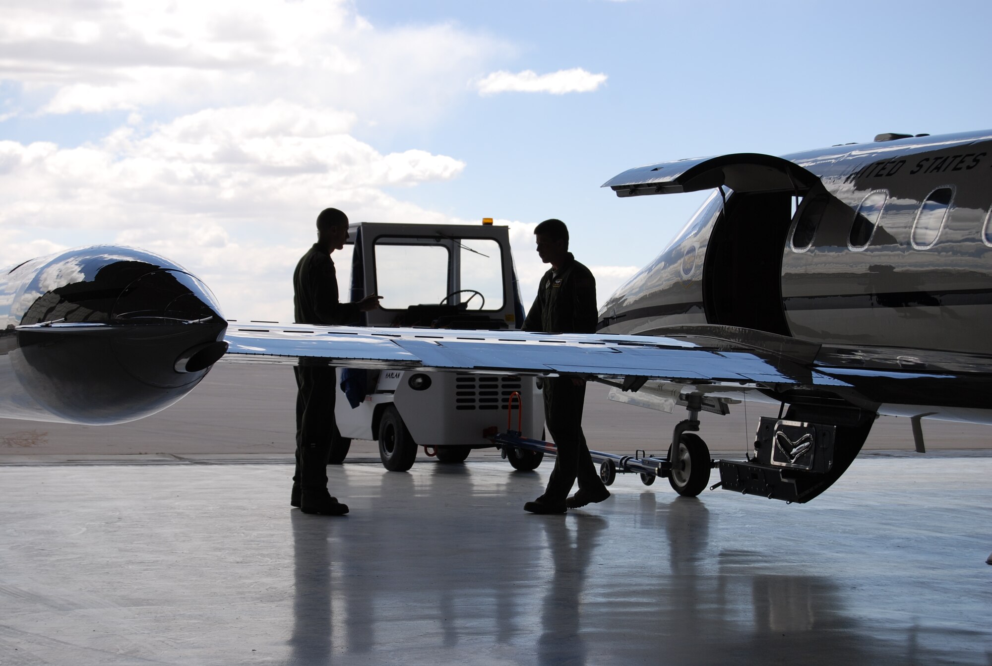 PETERSON AIR FORCE BASE, Colo. — Two pilots with the 311th Airlift Squadron perform preflight checks on their C-21A twin turbofan aircraft used for cargo and passenger airlift operations. This aircraft represents the final departure of the 311th from Peterson AFB and the Air Force after nine years of service. (U.S. Air Force photo/Michael Golembesky)