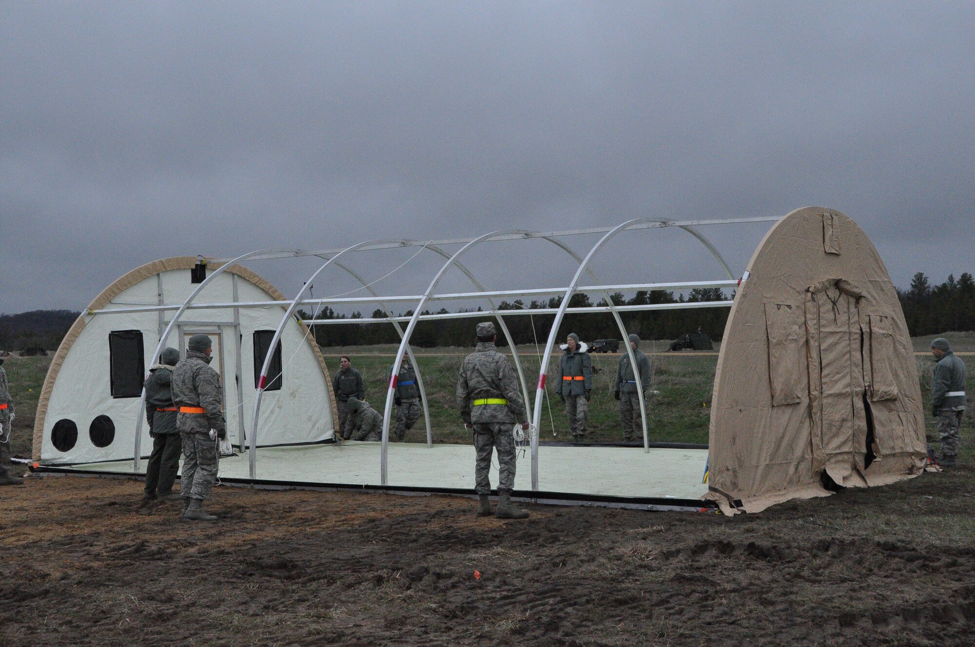 Air Force Reservists with the 433rd Civil Engineer Squadron instruct other Airmen on building tents for the sustainment phase of Exercise Patriot Warrior at Fort McCoy, Wisconsin May 3. The CE unit out of Joint Base San Antonio-Lackland were first involved in the bed down for the exercise and are now sustaining the Forward Operating Base as the main body moves in. (U.S. Air Force photo by 1st Lt. Denise Haeussler)