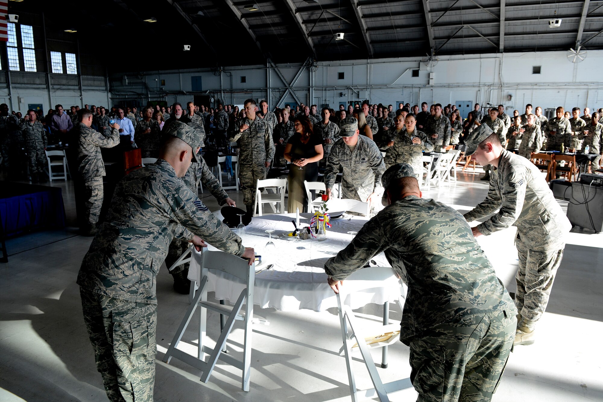 Members from the 6th Maintenance Group prepare the POW/MIA table during the 6th MXG “Knuckle Busters” awards banquet April 25, 2014, at MacDill Air Force Base, Fla. The original maintenance professional award was established in 1979 to recognize outstanding performance of direct, sortie-producing maintenance specialists. (U.S. Air Force photo by Senior Airman Melanie Bulow-Gonterman/Released) 